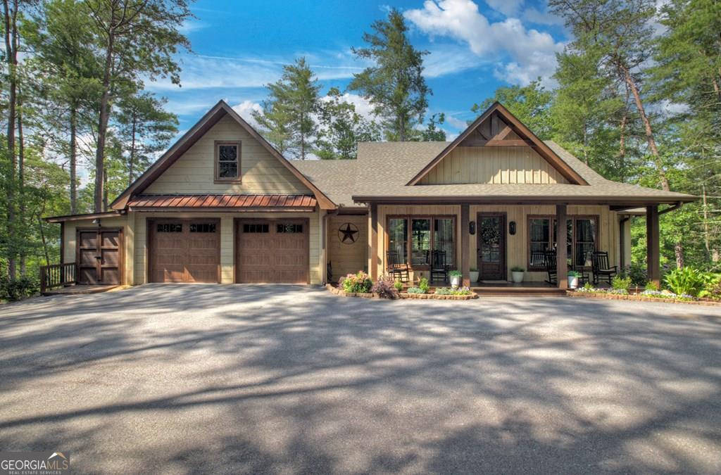^CUSTOM MOUNTAIN HOME^ This custom builder's home offers the best of the best including style, finishes & location. Perfectly situated conveniently between Blue Ridge & Ellijay nestled surrounded by USFS yet 5 min. to Hwy. 515/76 on all paved roads & paved driveway situated on x acres in a picture perfect setting. From the moment you pull up you'll discover the detailed construction quality both inside & out. Rocking chair front porch greets your entry & entire back of home features large covered porch overlooking the gorgeous long range mtn. views in the distance offering the best in outdoor living. Featuring 4BR's, 3BA's consisting of 3BR's on the main level w/ finished bonus room as 4th BR offering versatility of being home office, REC Rm/Den, exercise room, etc. Bonus space also has space designed for 4th BA should your needs want it as a private ensuite. Soaring cathedral ceilings, lots of windows & fixed glass, modern brickworks "real wood burning" fireplace, exposed beam rafters, circle sewn wood floors all add to the warmth & charm of this modern rustic design. Easy living in this open floor plan design centralized around the kitchen, living room & formal dining makes this the perfect home away from home or forever home. Featuring a 2 car garage & large studio for your tools & equipment + walk in foundation offers tons of additional storage space. Master suites offers separate walk-in subway tile shower & soaking tub, double vanity & dream walk-in closet. Upgrades galore including custom cabinetry w/ granite countertops, upgraded lighting & plumbing fixtures & more. If you're looking for the perfect opportunity, don't miss this one.