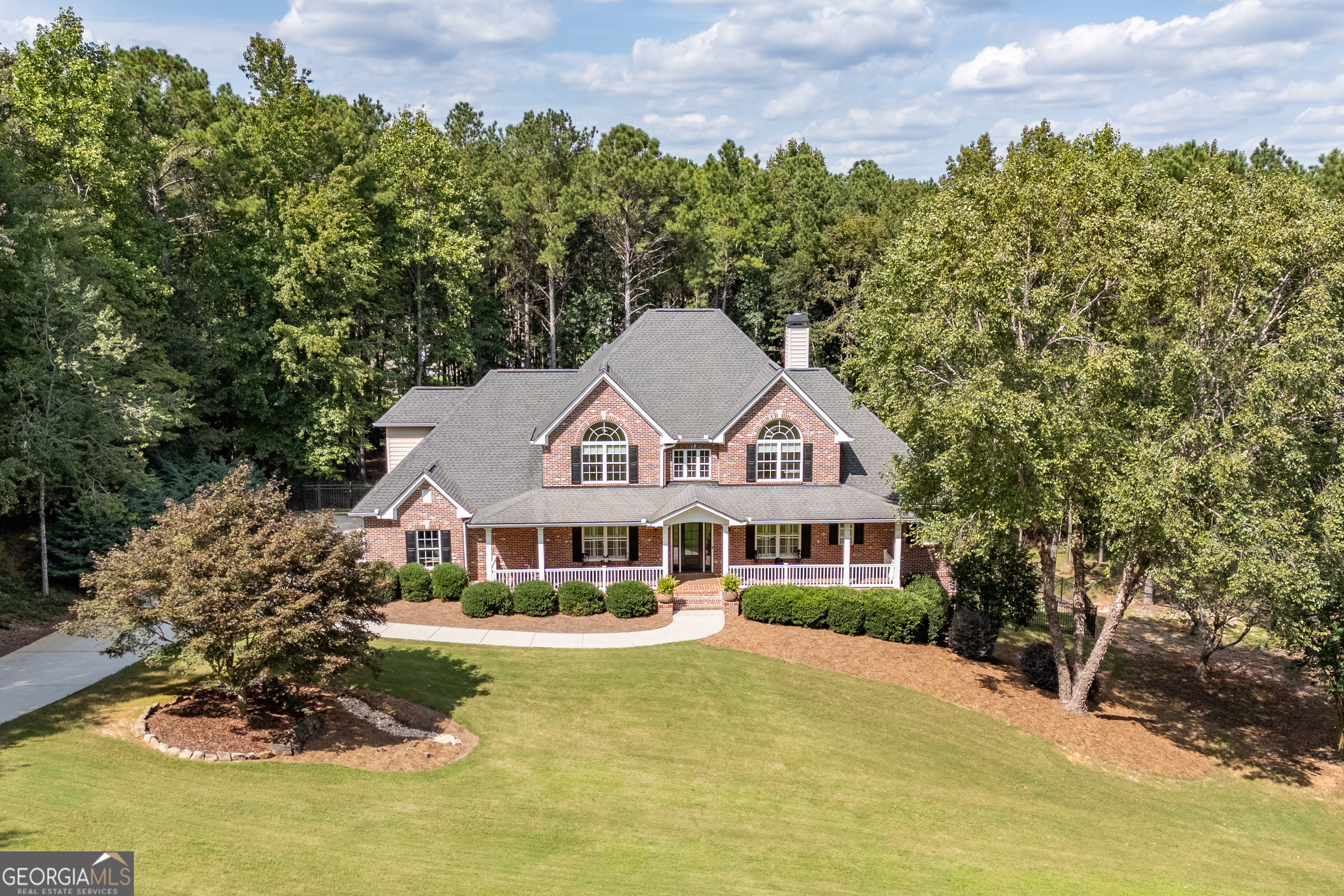 Welcome to Southern Elegance in Antrim Glen..... Experience the comfort and warmth of the South in this casually elegant custom home, perfectly set on 2.03 acres in the prestigious estate community of Antrim Glen. A classic rocking chair front porch welcomes you in, while the backyard unveils a BRAND NEW GUNITE SALTWATER POOL AND SPA-your own private resort. Inside, hardwood floors flow throughout the main living areas, complemented by FRESH PAINT THROUGHOUT, PLANTATION SHUTTERS , and crown molding. Just off the entry, an office with French doors overlooks the front porch, while the dining room-open to the kitchen and also facing the porch-offers a bright and welcoming space for entertaining. The gourmet chef's kitchen features granite countertops, high-end appliances, custom cabinetry, and abundant storage. Natural light fills every room, especially the vaulted great room with its COFFERED CEILING and WALL OF WINDOWS framing the pool oasis. The main-level primary suite offers his-and-hers closets, a SOAKING TUB and a STEAM SHOWER for the ultimate retreat. French doors extend the living space onto a deck with wooded privacy and wildlife views. It's the perfect spot for a peaceful morning coffee as the sun reflects off the pool, or to unwind at day's end. Upstairs, three spacious bedrooms with NEW CARPET, two full baths, and a bonus room with NEW LUXURY VINYL PLANK flooring provide incredible flexibility-ideal for kids, grandkids, visiting guests, or even a craft room, playroom, or home library. The terrace level is a true extension of the home-a COMPLETE PRIVATE LIVING SPACE with a full kitchen, bedroom, bath, half-bath for guests, laundry hookup, separate entry, and DIRECT POOL ACCESS. Perfect for MULTIGENERATIONAL LIVING, this level offers privacy while keeping loved ones close. A huge family room A huge family room anchors this level and can be closed off with French doors, creating the perfect gathering space or private retreat. With abundant storage and two safe rooms, this home offers comfort, luxury, and peace of mind. This exceptional property blends casual Southern charm with refined elegance-where natural light, thoughtful design, and resort-style living come together beautifully. If you're seeking a WELL-BUILT CUSTOM HOME in your own private corner of the world-yet just minutes from area conveniences-this is the one. Don't miss the opportunity to experience a meticulously maintained property that is truly move-in ready.