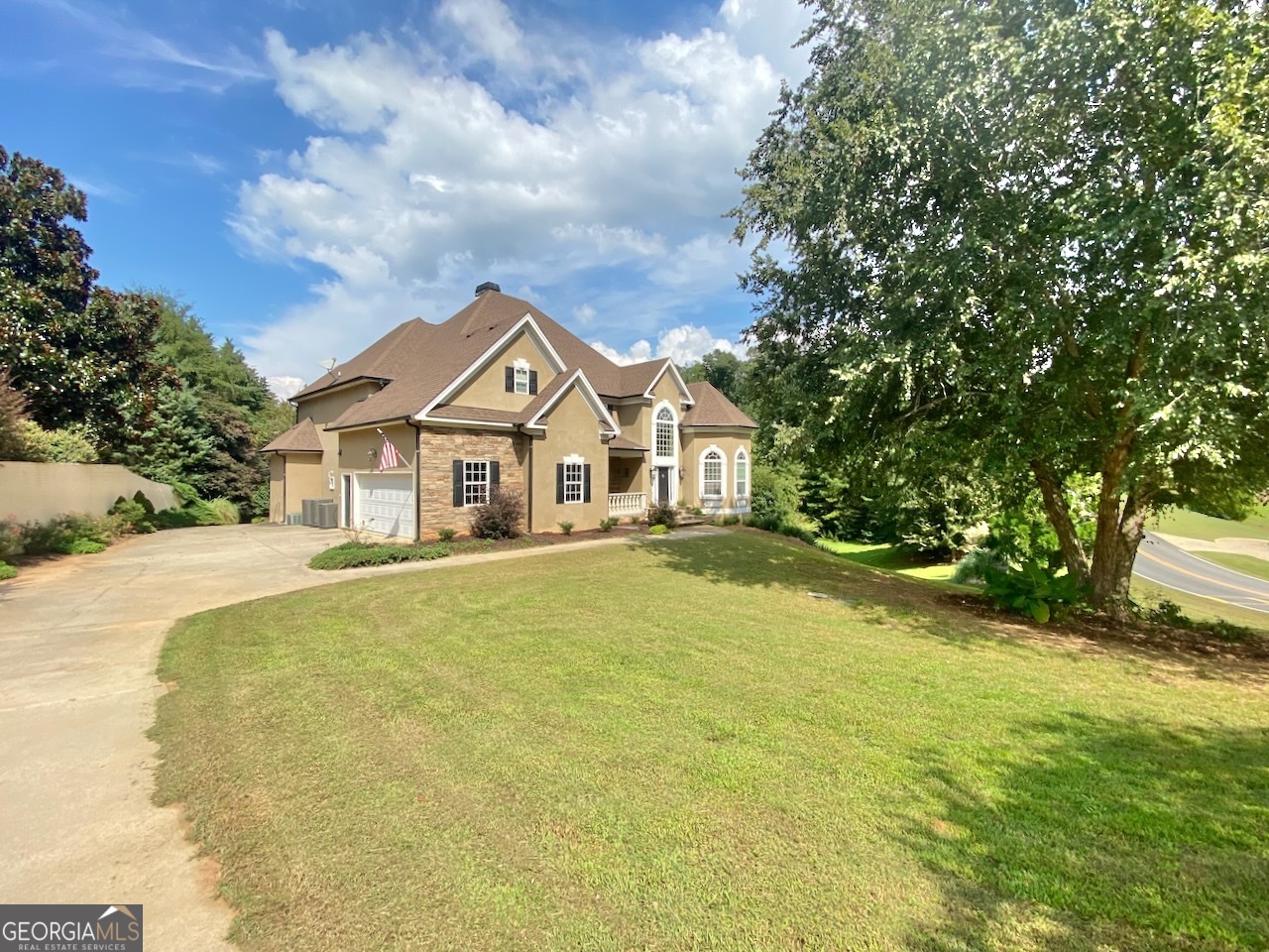 Nestled in The Cliffs at River Forest with a stream that feeds the Little Toweliga River and next to the 17th tee, this 5 bedroom, 4.5 bath home sits on over 1.5 Acres. Its spacious (roughly 6000 sf!), but still boasts intimate sitting and relaxing spaces, a media room, a game room with dry bar, and 2 kitchens. The view is beautiful to the lake, 16th green, and the covered bridge, but we couldn't escape the appeal of the multi level covered decks that offer unparalleled serenity and privacy while listening to the water as it danced over the rocks in the stream below. The community features a manned gated entry, clubhouse with bar and dining, professional 18 hole golf course, 2 swimming pools, tennis courts, soccer field, and more. There is an equestrian center and RV/Boat storage available. 30 minutes from Macon and roughly 30 minutes south of Atlanta, off the Johnstonville Rd exit in North Forsyth, the location is excellent for those who want the best of both worlds. Based on a report in February 2025, the school system was ranked 11th among all districts in Georgia and 1st among all districts in the Macon area.