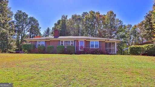 Charming 4-sided brick ranch on 1.45 acres with a full basement! The basement includes a finished full bath, a cozy wood-burning fireplace, and a private exterior entry to the backyard. The updated eat-in kitchen features granite countertops, stainless steel appliances, and opens to a relaxing screened porch. The family room boasts hardwood floors and a gas fireplace, perfect for gatherings. Three bedrooms and a full bath complete the main floor. The expansive yard offers plenty of space for a garden, children's play area, firepit, or outdoor entertaining. An outdoor shed provides extra storage for your riding mower and gardening tools. Conveniently located near I-985, I-85, and the new Northeast GA Medical Center in Braselton, this home is ideal for peaceful living with easy access to amenities.