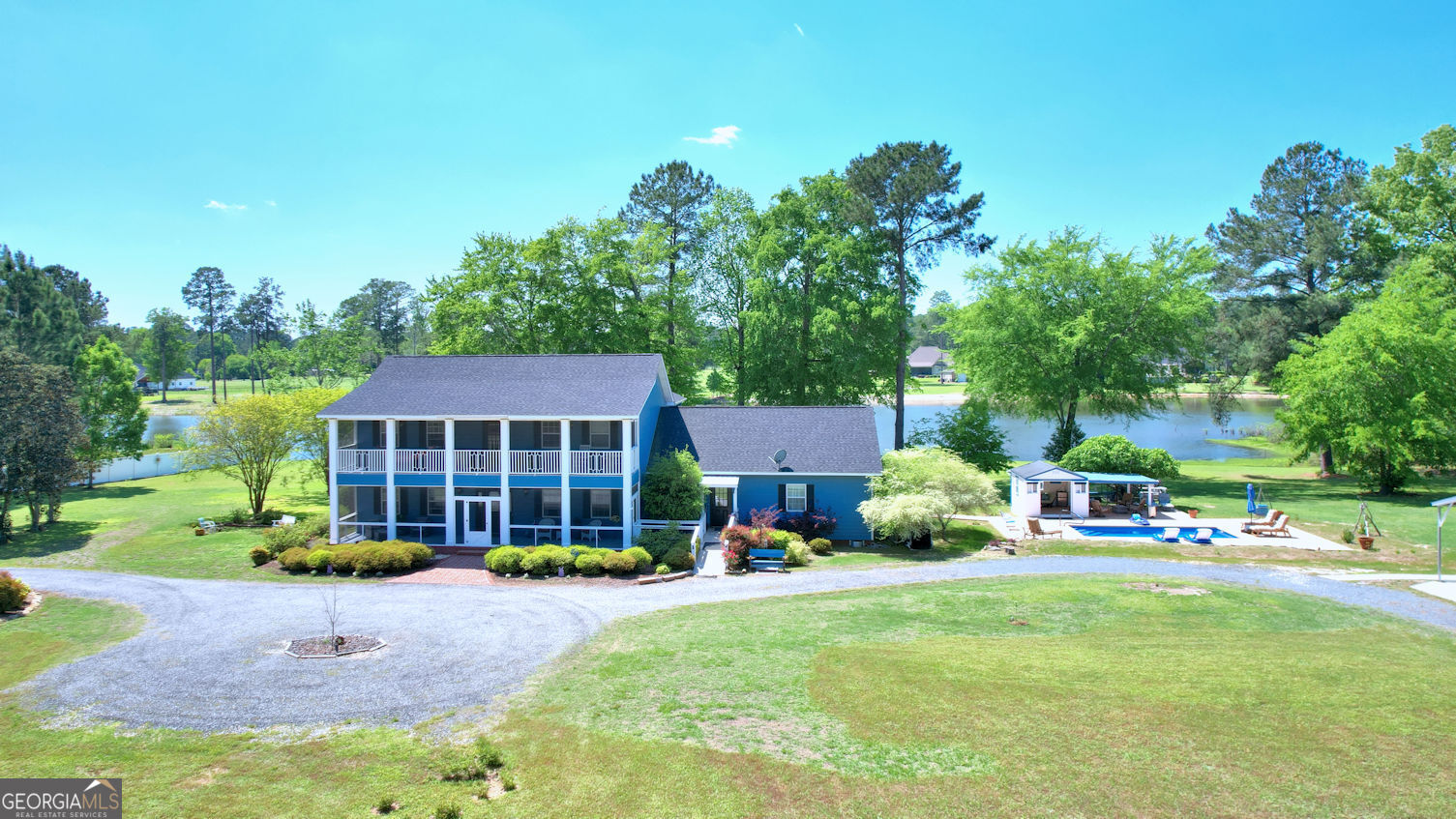 If you're looking for a little bit of PARADISE, this is it!!! Quiet, serene on 5 acres of land with beautiful mature trees for privacy. On the back is a 12-acre pond with private fishing deck and PLENTY of fish! There are 3 large screened in porches to enjoy sunrise and sunset. A beautiful saltwater heated pool. Pool house with attached cabana for relaxing and shade. Detached 2 car carport with plenty of storage and covered parking. The home has 5 bedrooms and 5 bathrooms. A primary suite is on the first floor as well as an optional second primary on the second floor. Also, on the first floor is an additional guest room with a private bath. Upstairs there are two additional bedrooms each with 2 closets and private bathrooms. Entering the home is a BEAUTIFUL tiled foyer that greets you with a clear view through the back of the home to the pond! Formal dining room with built-ins. Gas fireplace centrally located in the living room. An additional living space both upstairs and down with wall-to-wall windows for enjoying the VIEW! The kitchen is large and with TONS of storage and space for a large table seating 8-10 people easily! The refrigerator and stove are 2 years new and energy efficient. The large laundry room has outside access. The home is also wheelchair accessible! This beauty has even MORE amenities than listed here!!! You must come experience this haven for yourself!!! Call us today to schedule a tour!!!