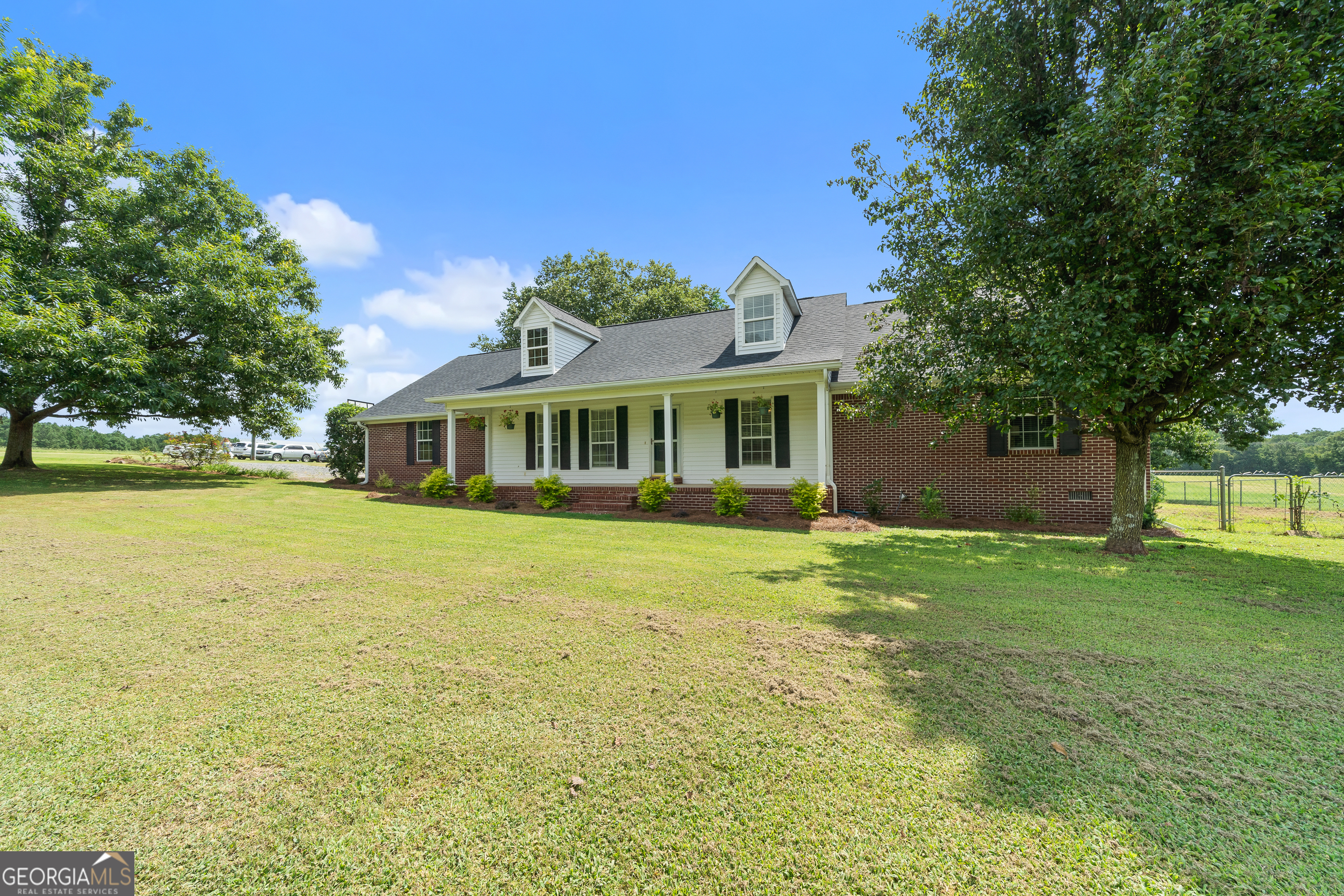 17-Acre Turnkey Farm in Monroe County - All Brick Home, Pool, Horse & Livestock Facilities, and Income-Producing Pastures Discover the best of farm life and country living on this beautiful 17-acre property in Forsyth, Georgia. A traditional brick farmhouse, this home offers 4 bedrooms and 3 full baths, blending timeless style with modern updates. The main level features 3 bedrooms and 2 baths, while the upstairs provides a spacious guest suite with a full bath, large closet, and attic access for storage. Recent upgrades include a new roof, LPV flooring, stylish lighting, and a spacious new deck perfect for outdoor living. At the heart of the home, the country kitchen boasts granite countertops, custom wood cabinetry, a portable island, bar seating, and an open layout ideal for entertaining. The great room offers warm, welcoming living space, while the sunroom opens to a Craftsman-style covered porch. Step outside to enjoy your private retreat with a pool and fenced backyard. The land features lush Alicia and Coastal Bermuda grass pastures, ideal for horses, livestock, or hay production-with income-generating potential. Equestrian facilities include a well-equipped barn with stalls, wash pad, and tack room. Additional barns and outbuildings provide ample space for hay and equipment storage, along with run-in shelters and paddocks. Whether you're looking to operate a farm, board horses, or simply enjoy the quiet beauty of Monroe County, this property delivers convenience, comfort, income potential, and opportunity. Additional adjoining acreage with pond and hay storage building is available for buyers who want to expand their vision.