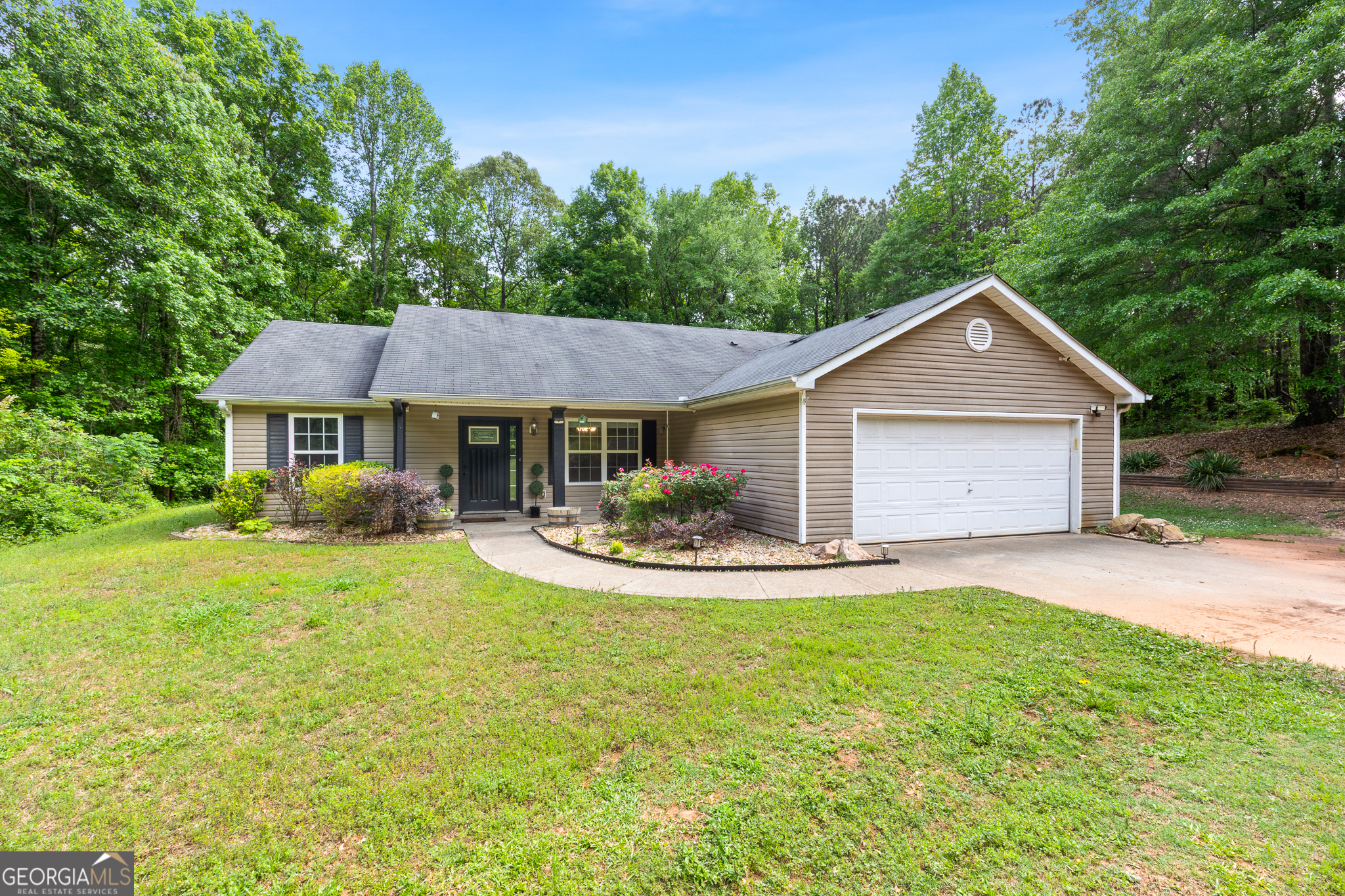 Charming Ranch on Nearly 2 Acres in Sharpsburg! Come see this beautiful ranch home nestled on a spacious and private lot in sought-after Sharpsburg. Sitting on nearly 2 acres, you'll love the oversized front yard, flat backyard, and peaceful setting that offers both space and serenity. Step inside to find fresh paint in the primary bedroom and hallway, luxury vinyl plank flooring throughout the main living areas, and vaulted ceilings that create an open, airy feel. The floor plan features a large separate dining room, a spacious kitchen with stainless steel appliances, and a cozy breakfast area that flows into the living room-perfect for entertaining or relaxing. All bedrooms are located on the main level with a desirable split-bedroom layout and two full bathrooms. The primary suite is generously sized and provides a peaceful retreat. Upgrades include: Driveway alarm system and 4K surveillance system that can be accessed once again, UV lighting on the HVAC system, Honeywell smart thermostat, High-efficiency air filtration system, Whole-house air duct system, New insulation in the attic and above the garage. This move-in ready ranch is located in the highly rated Coweta County School District and offers the perfect blend of privacy and convenience. Don't miss your chance to own this bright, updated home with room to breathe-schedule your showing today!