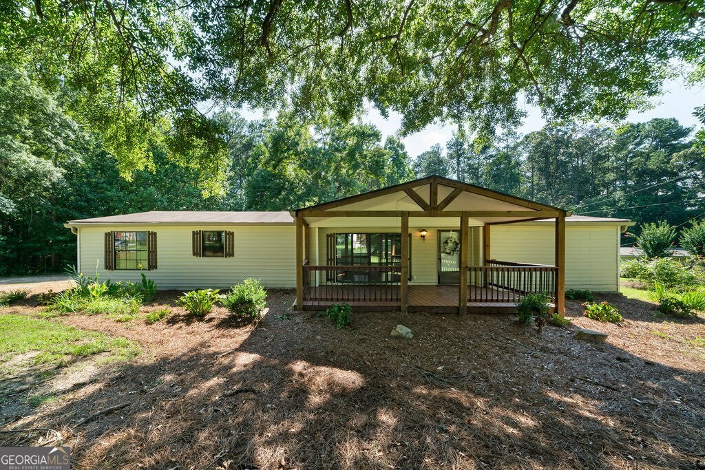 Charming and spacious, UPDATED, MOVE-IN READY 3-bedroom, 2-bath double wide mobile home on a permanent foundation is ready for YOU! (Yes, the titles have been retired!!) The home is located on a beautiful, usable, flat 1.01-acre lot in desirable East Paulding. This home features a spacious, roommate-style floor plan for privacy, with brand-new carpet and paint in the bedrooms. The large kitchen offers stainless steel appliances, including a GAS STOVE, and ample cabinet and counter space. The open-concept dining area overlooks the living room as well as the kitchen. Both bathrooms are completely remodeled with luxury vinyl tile, new vanities, mirrors, tub or shower, and lighting. Enjoy outdoor living with a 200 sq ft covered front porch, a 480 sq ft covered back deck, plus a 120 sq ft attached storage room and detached shed. This home has it all, affordable price, condition, location, and has convenient access to everything! Schedule your tour today!!