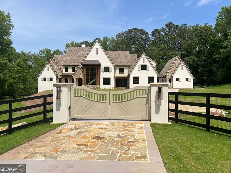 Beautiful Custom Home awaiting your finishing touches in exclusive Milton. This amazing New Construction European Provencal cement stucco and stone home combines all the Traditional luxuries with Modern style. This estate home is situated on a private 4.48 acre lot.  The Open Concept floor plan has a custom modern Staircase visible from the front through the dramatic black framed two story window. Upon entering the Iron Framed double doors the two story Family room opens to the beautiful backyard. As you walk out the main level into The backyard Oasis, complete with expansive Travertine patio  you look out to the beautiful pool, and spa facing the private woods with a creek in the distance.  Pool bathroom is just one of the details this home includes. The Chef's kitchen has a dramatic marble island which opens to the Family Room and Keeping Room. Kitchen Boasts a 60" Wolfe Duel Fuel Range, Two Miele Dishwashers, Sub Zero Refrigerator and Separate Freezer, Large pantry, Butlers pantry, and Mud Room. This home has Two Laundry Rooms. The main floor includes an Owner's Suite with separate sitting room, which has private balcony. Large bathroom, which also opens to balcony, and amazing His and Hers closets. The Guest En Suite, also on main, has its own door leading to the back guest terrace over looking small fountain. There are 3 additional bedrooms upstairs with private baths and an oversized bonus room. The finished Terrace level includes an Office, Exercise Room, Steam Shower,  Cold Plunge Room,  Bar, Theatre Room, and tons of storage! This is an amazing Home for Entertaining. 3 Car garage and an additional separate 2 Car Garage with option of future teen or in-law suite above. Amazing Milton location! Minutes from Down Town Alpharetta and Avalon! Great Schools! Professional photos coming soon!