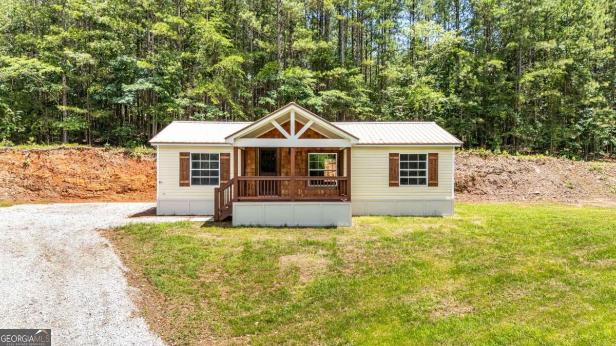 Charming Renovated 2 Bed / 2 Bath Mobile Home with permanent foundation on .84 acres in Fairmount, GA! Welcome to your perfect blend of peaceful country living and modern convenience! This beautifully renovated 2001 mobile home offers 2 spacious bedrooms, 2 full bathrooms, and sits on a generous .84-acre lot with no HOA or restrictions-giving you the freedom to make it your own! With approximately 980 sq ft of thoughtfully updated living space, this home is ideal for first-time buyers, owner-occupants, or investors looking for a great rental opportunity. Step inside to find a light and airy open floor plan featuring new LVP flooring throughout, fresh interior paint, modern trim and fixtures, stylish tile work, and a custom backsplash in the kitchen. The large living room flows seamlessly into the kitchen, creating an inviting space for entertaining or relaxing. Both bedrooms offer their own private bathrooms, providing comfort and privacy for family or guests. A separate laundry room adds convenience to daily living. Enjoy your morning coffee on the covered 14x8 front porch, or step out to the 4x5 back stoop and take in the beautiful open yard-perfect for gardening, outdoor activities, or future expansions. Located in Fairmount, Georgia, this home offers the best of both worlds: tucked away in the quiet countryside, yet conveniently positioned between Highways 75 and 515 for easy access to shopping, dining, and travel. Don't miss this move-in ready gem-schedule your showing today and explore all the possibilities this wonderful property has to offer!