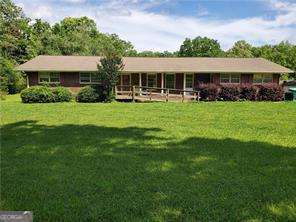 Live, work & play here on level 3.16 acre plus can be income producing by renting out 2nd home. Main Home Is a 4bd 2ba brick ranch home w/hardwood floors, foyer, great room, din, kit laundry/storage rm. w/extra storage rooms in carport/garage. 2nd home is a 2bd 1ba liv & kitchen. Large 5 Car metal Garage/storage building, 2 additional buildings & a shed. (1 portable building does not stay). Zoned LI so there is a lot of possibilities with this one. Property has a small creek running alongside one part of back of property line, 2 pear trees, several fig trees, blueberry bushes & Blackberries. Large garden area. also area for a Pool if someone wanted to add one directly behind the home or you can just play in the beautiful creek. Located close to Downtown Ball Ground, short distance to Canton & Jasper w/easy access to Interstate makes this property very important/valuable for all types of functions. This property would also make a great business or commercial location.