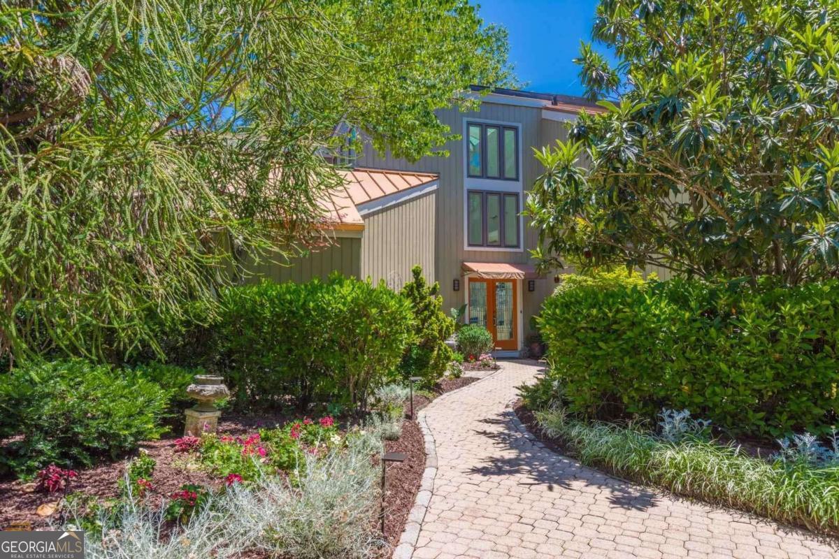 Welcome to your private retreat! This fully updated 70s Contemporary Home sits in a beautifully landscaped 3.32-acre double lot surrounded by nature: Magnolias, Fruit Trees, Garden Area, wooded perimeter. You won't believe you're only 18 miles from the city. The vast, open-concept entryway and great room are perfect for entertaining. Take the fun to the outdoor entertainment area, featuring a pool, pool house, outdoor gourmet kitchen, fire pit, and shower. Waterfall and pond feature, and heated tile floors in the master. The split bedroom plan on the upper level provides ample living space and privacy. Huge In-law suite on the lower level includes a kitchenette and home theatre with a projector. With this hidden gem, you won't believe how much you get for the price in the exclusive Lake Spivey area! Home is occupied. Please schedule an appointment.