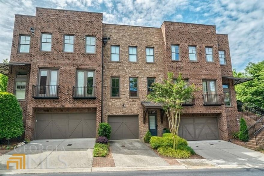 Incredible location and irresistible style in this urban-suburban gem with wonderful outdoor space. Located in Providence, the only gated community with pocket parks and a dedicated dog park in the heart of downtown Roswell. Stellar appointments with site finished hardwood floors throughout, remote control blinds, upgraded lighting, and Kohler bath fixtures. Light filled kitchen with white cabinetry, center island, customized pull-puts, quartz countertops, stainless appliances, and mosaic backsplash. Upper-level features primary suite with spa bath & two walk in closets. Plus secondary ensuite. Finished terrace level provides flex third bedroom with full bath or office/media space with walk out to private courtyard. Enjoy morning coffee and evening cocktail on covered porch off main level. A turn-key lifestyle with HOA maintaining landscaping & exterior. Literally walk out front door to the shops and restaurants of Canton Street.