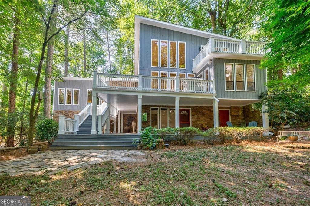 Truly One-of-a-Kind in Dunwoody and Metro Atlanta! Tucked away on a quiet private street in the coveted Vanderlyn Elementary district, this extraordinary contemporary home sits on over an acre of total privacy-yet is just a short walk to top-rated schools and local conveniences. A rare fusion of contemporary living, natural serenity, and cutting-edge technology, this property features the ONLY PURPOSE-BUILT, Georgia Power-verified CRYPTO MINE in the state, officially approved by the City of Dunwoody. It's also a DREAM SETUP for hobbyists or tech entrepreneurs-with reinforced flooring and robust power infrastructure to support heavy machinery or advanced systems. A long, secluded driveway welcomes you to this home, where you'll find striking architectural details including soaring ceilings and floor-to-ceiling windows which illuminate the stunning two-story dining room. The sunlit, recently upgraded kitchen with a keeping room opens to a large wraparound deck-perfect for entertaining or enjoying the peaceful wooded views. Entertaining and relaxing are perfect in the spacious great room with high ceilings, a walls of windows, and a striking stone fireplace. Step out to a covered porch with its own fireplace and peaceful wooded views. The main level offers two bedrooms + a full bath, while the upper level is dedicated to a private primary suite featuring a spacious bath with jetted tub, large shower, dual vanities, walk-in closet, and an added laundry room. The finished daylight basement includes a private bedroom and bath, a large flexible living/entertainment area, and its own entrance with a wraparound porch-ideal for guests, a home office, or multi-generational living. PLUS, there is incredible CUSTOM-BUILT WORKSHOP, professionally insulated with Rockwool for both fire protection and soundproofing. Full specs and details on the workshop and crypto mine available upon request! BONUS FEATURE: The crypto mine can run 3 Fog Hashing C6 immersion tanks, 3 coolers and18 crypto miners (6 per tank) at full at power indefinitely. Immersion tanks available separately!