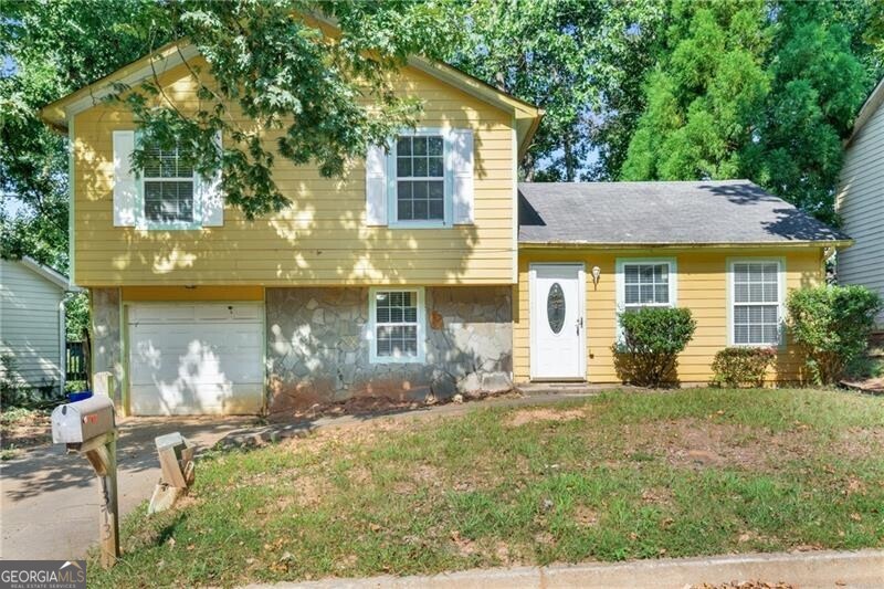 Charming Split-Level in Stone Mountain! This 3-bedroom, 2-bath home offers spacious living with a cozy den featuring a fireplace, a well-appointed kitchen with beautiful cabinetry, and a large primary suite. Enjoy the convenience of a 1-car garage and a prime location near I-285 and US-78 for easy access across the metro. Excellent opportunity for investors or homeowners alike with solid rental history and excellent maintenance! *Property is currently vacant but part of a portfolio of 13 other properties that are currently tenant occupied with 30-day notices.