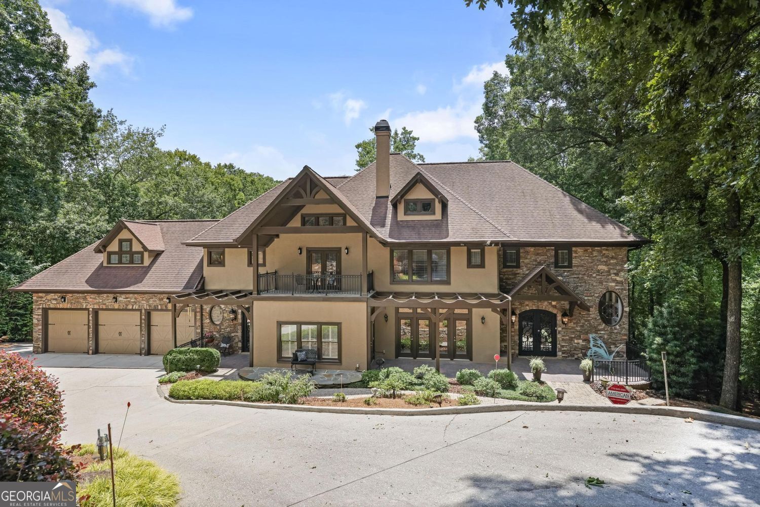 A private retreat nestled right in the heart of the city! Experience the elegance of North Georgia in this luxurious, stunning Sandy Springs estate. This extraordinary custom-built home is a true hidden gem. Set on nearly 2 private acres (1.94 acres), this elegant residence offers 5 spacious bedrooms, 4 full baths, and 2 half baths - the perfect blend of luxury, comfort, and serenity. From the moment you step through the grand iron front doors, you'll be captivated by the thoughtful design and breathtaking views. A dramatic wall of windows floods the home with natural light, highlighting the sun-drenched breakfast room and gourmet kitchen. Enjoy your morning coffee on the screened-in porch or host unforgettable gatherings in the large formal dining room. Step outside and take in the picturesque scenery from three levels of expansive Trex decking overlooking a tranquil pond - your own slice of paradise. This meticulously maintained home boasts: 3 fireplaces for cozy evenings, Attached 3-car garage, plus a climate-controlled detached 3-car garage at the rear of the property, Whole-house industrial generator powered by a 6-cylinder Ford engine, serviced twice annually, Irrigation systems in both front and back yards, New 80-gallon water heater installed in 2022, 4 HVAC systems, all professionally maintained twice a year, and Durable cement and stone exterior. The luxurious primary suite is exceptionally spacious, offering a peaceful retreat at the end of each day. Voluntary HOA. This is more than a home - it's a rare opportunity to own a true estate property in sought-after Sandy Springs. Welcome home!