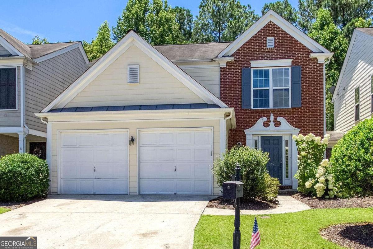 Discover the perfect blend of comfort, style, and privacy in this beautifully updated townhome located in the sought after Woodlands community. With no shared walls - each unit is uniquely seperated by individual storage spaces so you can enjoys the privacy of a single family home with the convenience of townhome living. From the moment you step into the welcoming foyer, you'll notice the attention to detail. New flooring was recently installed throughout the main level, fresh paint in every room, updated granite countertops, new stainless steel appliances in the kitchen, and a new hot water heater for added peace of mind. The open concept living area features a cozy fireplace with lots of windows overlooking the level backyard framed by mature, wooded views, providing a serene and private escape! The chef -inspired kitchen offers a large breakfast bar island ideal for entertaining, a spacious pantry, and a seamless flow into the great room, perfect for moden living! Additionally, a laundry room with built-in cabinetry is conveniently located on the main level. Upstairs, the luxurious primary suite features a large walk-in closet, and a spa-inspired bathroom with an oversized, glass-enclosed shower. Three additional bedrooms and a full bath provide ample space for famiy, guests, or a home office. The Woodlands community features resort like amenities including 2 pools, the main pool has water slides and a kiddie area, a club house, pickle ball, tennis courts, a playgorund and walking trails. Conveniently located near fabulous shops and restaurants, Downtown Woodstock, and easy access to Roswell, Alpharetta and East Cobb. Experience the charm, convenience, and community of The Woodlands - schedule your tour today!!!