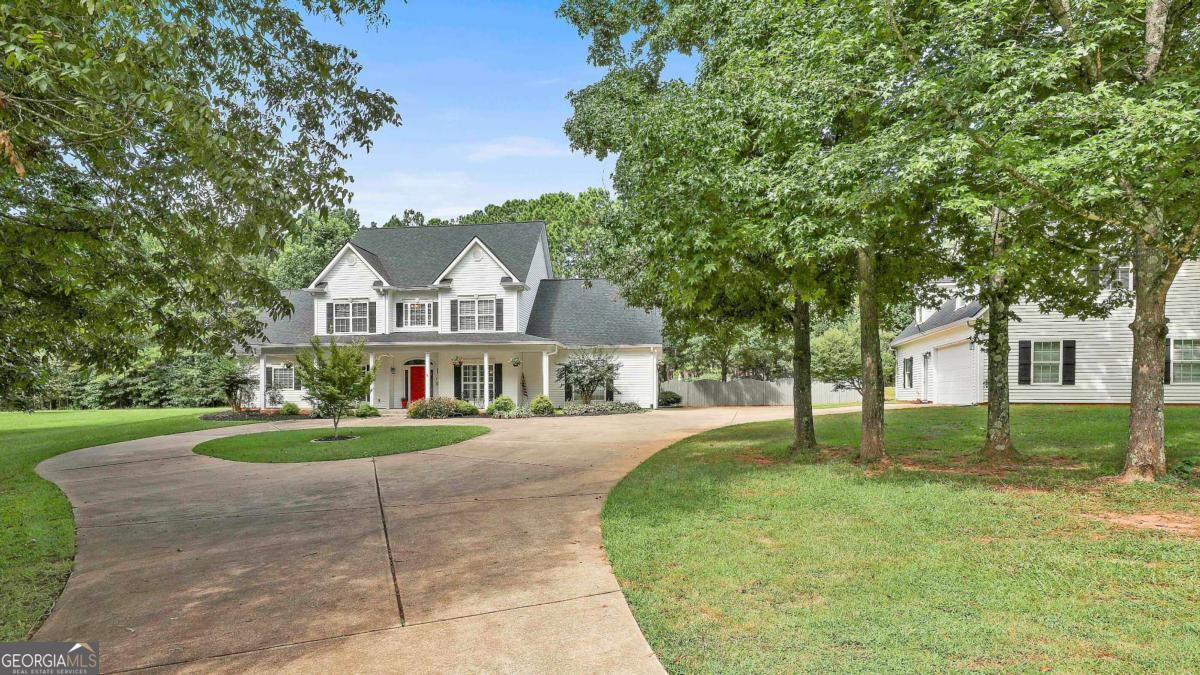 FABULOUSLY UPDATED HOME W/ SPARKLING POOL, ACREAGE & UNIQUE GUEST HOUSE w/ 2 CAR GARAGE IS READY FOR YOU + NEW ROOF on Main & Guest Home! As you approach the convenient Circular Driveway, you'll find Southern Charm w/ welcoming Rocking Chair Front Porch. Look to the right of the huge parking pad to see detached Guest House offering small Kitchen, Primary Bedroom & Bathrm on main + 2 add'l rooms upstairs - Imagine the possibilities! Step inside the main family home to beautiful hardwood floors, ALL UPDATED KITCHEN w/ New Quartz counters, fresh painted cabinets, huge center Island & an abundance of cabinets. NEW Painted walls, nearly throughout makes it even more move in ready for you. Bright windows in Family rm w/ built ins overlook the covered patio & sparkling inground Pool. Spacious Primary Bedroom & guest bedrms on main, offer comfort & flexibility for home office or guests. Huge Bedrms upstairs w/ lg closets & 2 full Bathrms + a lg Bonus rm gives everyone their own space. The Backyard is like an oasis, fenced yard around the Pool + plenty of patio areas perfect for entertaining. Abundant foliage catches your eye & sets the tone for a garden pool party + soothing sounds of the waterfall in the backyard. Flowing open acreage adds to the Southern Charm of it all. This is a Unique Home that won't last long + NO HOA! Quick access to shops, restaurants, dining & 25 min to Atlanta & Airport!