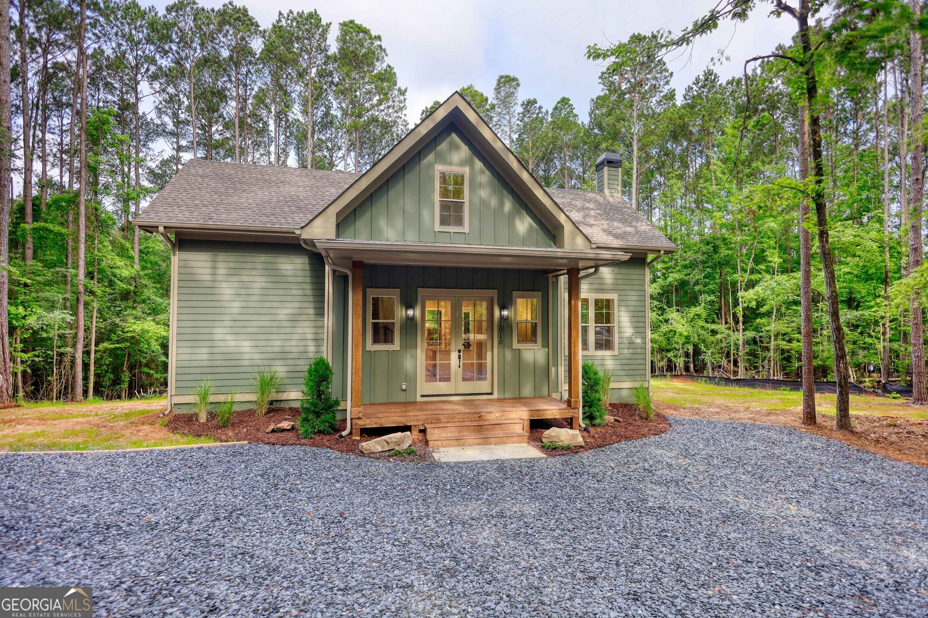 Custom designed new construction with Lake Oconee access from your own personal dock. This Hardie board craftsman sits on 1.37 acres of level wooded privacy, as a corner, cul-de-sac lot. Sought after master on main, two bedrooms upstairs, PLUS a bunk room for your guests makes this the quintessential gathering place. Also upstairs is the place perfect for an office, recreation, or sitting area that leads to a large balcony, where one can peek through to the lake seasonally. On your main level, the robust kitchen island is centralized for extra counter space or for loved ones to pull up a stool. The open concept here allows you to be present for those in the living room, enjoying the stacked stone fireplace, or those eating at the dining room table. Behind the kitchen is the master bedroom, with French doors leading to the massive back deck with two staircases descending onto the backyard. An additional set of French doors line the back of the home at the living room, for easy access outdoors at any time. Take the short walk to your assigned slip at any time, where only a select few neighbors own slips. The North end of Lake Oconee is mostly untouched; you will not find wake and traffic here! Make an appointment today and let's put your LAST name on this FRONT door!