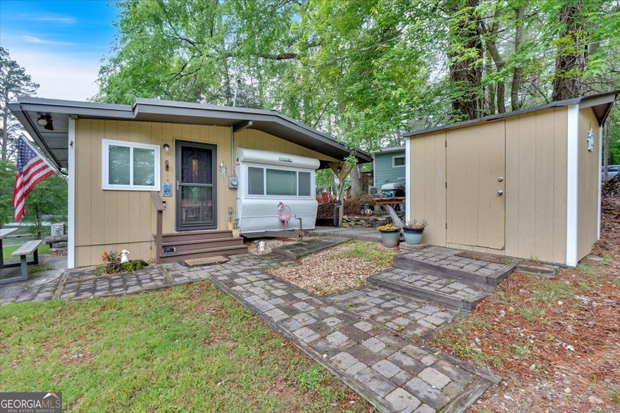 Welcome to your perfect lakeside getaway! This charming cabin nestled in Glade Marina offers views of Lake Allatoona and is the perfect retreat for weekend getaways or simply a serene place to relax and recharge. Step inside to an open-concept living space that feels bright, airy, and inviting. The thoughtfully designed kitchen features a refrigerator, stove, microwave, dishwasher, along with ample cabinetry and countertop space - ideal for cooking up your favorite meals. The spacious bathroom is completed with a washer and dryer. Direct lake views from the living room and master bedroom. Every inch of this cabin is designed to maximize comfort, making it a truly turn-key property for anyone looking to enjoy the lake. This property is located on the Corp of Engineers and there is a land lease fee of $728.00 per month. Cash purchase only and will be bought with a Bill of Sale. Take advantage of this rare chance to own a charming getaway in one of Lake Allatoona's sought-after marina communities!