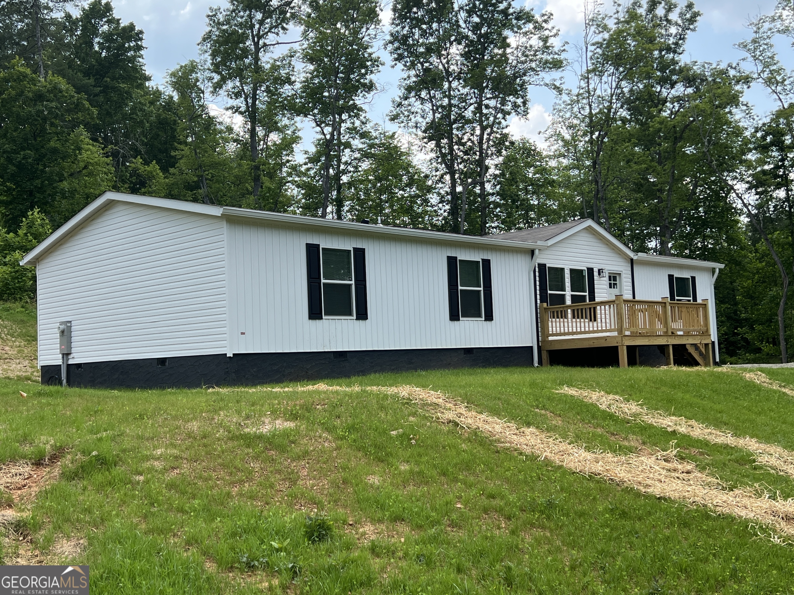 Commuter's dream! Just over an acre of beautiful country living! Located close to highway 515, and situated between Blairsville and Blue Ridge. You are going to love this beautifully done, 1791 sq ft home! This open concept home has so much space, with 4 bedrooms with 2 baths, kitchen, dining area, living room, den, and separate laundry area. Your kitchen has plenty of storage space in the cabinets, as well as a large pantry. Enjoy the coffee station that's located off of the kitchen, and spacious laundry room, with extra storage space. You will have plenty of room for outdoor entertainment, with your large front deck and expansive rear deck; as well as a great yard space. Lots of extras in this home, including upgraded bluetooth controlled heating and air. Home is prewired for solar and plumbed for a dehumidifier if desired. The home has a wonderfully laid out master bedroom with a walk in closet. As you enter the master bath, you'll find double vanities and an oversized tub. The master bath also has another walk in closet, giving you plenty of space for all of your storage needs. The other three bedrooms are located on the other end of the home, and share a full bathroom with the main living area. This home is the Morocco plan from Clayton homes; and has the smart home features for energy efficiency, featuring bluetooth app connectivity and energy saving operation. Call me today to schedule your showing, because this home wont last long! Roy Rose 706-968-1652