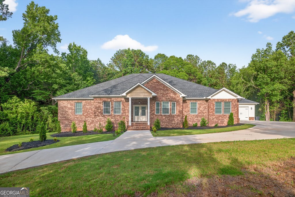 New construction, quality-built home tucked away on just over 6 secluded acres in Oxford, GA. This stunning 5-bedroom, 3.5-bath ranch offers the perfect blend of privacy, space, and functionality. Thoughtfully designed for comfort and efficiency, the expansive floor plan features a massive master suite with a spacious bathroom and oversized walk-in closet. 2 sets of Jack-and-Jill bedrooms. The open concept living area flows seamlessly to a covered back porch. Perfect for entertaining or relaxing in the peaceful surroundings. A 4-car garage provides ample space for vehicles, equipment, or storage. Energy efficiency is a top priority, with spray foam insulation throughout ensuring year-round comfort and lower utility costs. As an added bonus, the home directly in front of this property is also for sale, creating a rare opportunity for multi-generational living or extended family to live close by. This is a true retreat offering space, quality, and versatility in a tranquil Oxford setting.