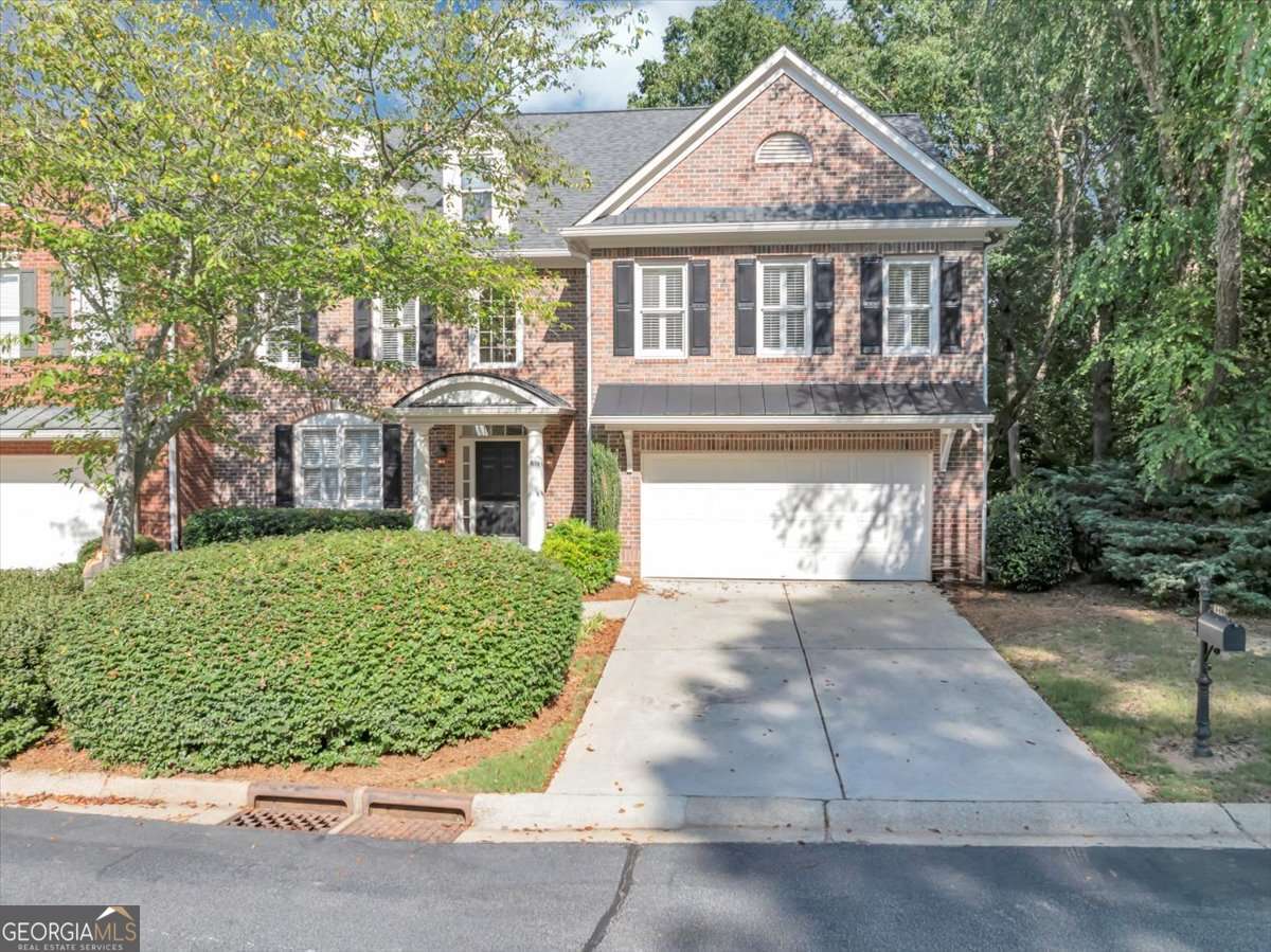Rare End-Unit Townhome in Vinings Estates with Main-Level Owner's Suite This elegant John Wieland townhome offers stepless entry and a hard-to-find primary suite on the main level. The bright, open layout features a two-story foyer, hardwood floors throughout the main, and a great room with soaring windows, custom built-ins, and a marble gas fireplace. The kitchen boasts sleek black stainless steel appliances and flows seamlessly into the dining area-ideal for entertaining. The main-level owner's suite includes vaulted ceilings, plantation shutters, and a spa-style bath with soaking tub and glass shower. Upstairs you'll find a loft with built-ins and two spacious bedrooms, each with private en-suite baths. The finished terrace level is perfect for a home office, with plenty of storage space. Enjoy top-tier amenities including three pools, tennis courts, and a clubhouse-all in the sought-after Vinings Estates community.