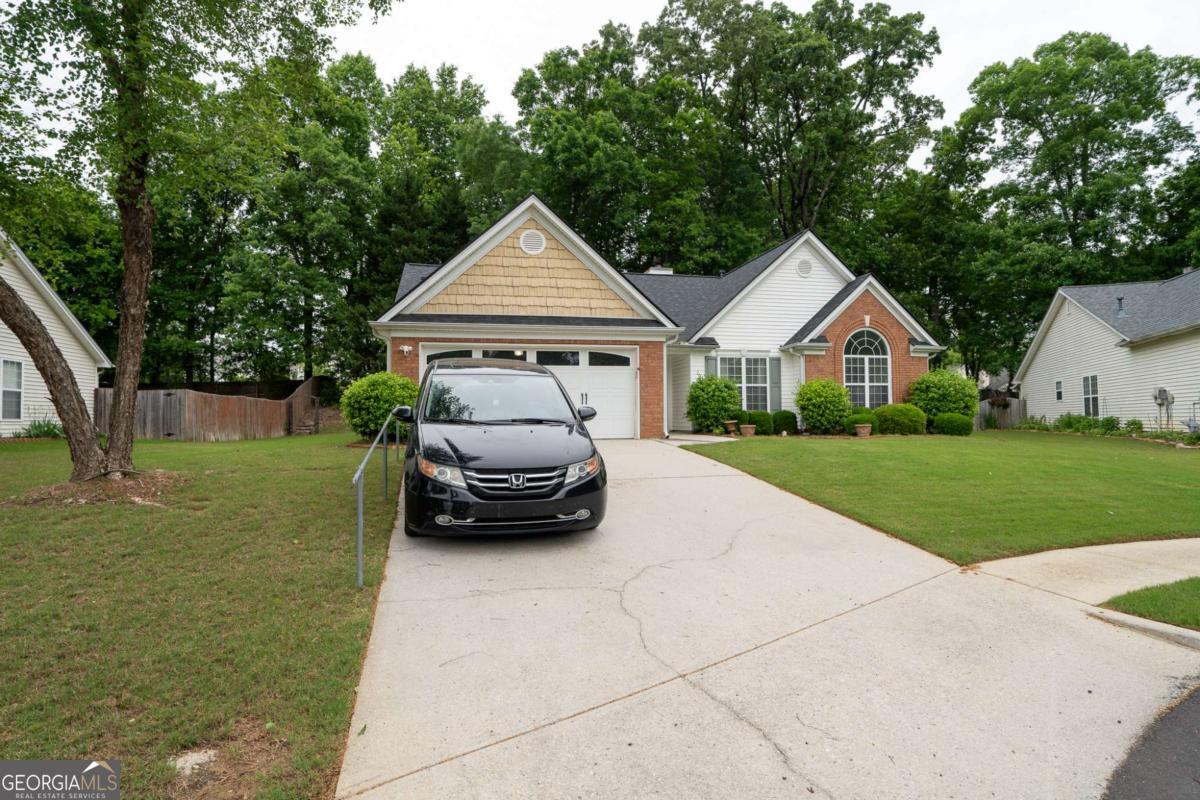 MOTIVATED SELLER/2000 towards closing costs. Welcome home to this beautifully maintained ranch with a charming brick front, located 5 minutes from Hwy 85 in Hamilton Mill, in the sought after Ivy Creek and Seckinger School District. High vaulted ceilings, neutral colors and abundant natural light is very inviting. The living area includes an entrance foyer, a fireside living room, a separate dining room, a lovely sunroom and an eat-in kitchen. The kitchen has vaulted ceilings, including a kitchen island. The oversized owner's suite boasts vaulted ceilings, a walk-in closet and an en-suite bath featuring dual vanities. Lots of windows and lots on sunshine in the home. Additional highlights of the home include spacious secondary bedrooms with crown molding and ceiling fans, along with a large secondary full bath, a laundry room with shelving, a new water heater installed in 2024,and a 5 year old roof. The flooring in the Living room is less than 5 years old. Nestled in a quiet neighborhood, this home offers convenience with proximity to shopping, schools, and parks, making it the perfect blend of comfort and modern living.