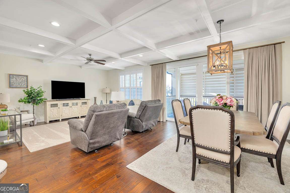 This beautifully furnished 3-bedroom, 2-bath luxury villa is located in a highly desirable gated community, offering both comfort and privacy. Situated on the top floor, this home features an open floor plan with hardwood floors and plantation shutters throughout, providing a stylish and inviting atmosphere. The spacious primary bedroom boasts an ensuite bathroom with dual vanities and a large, tiled shower for a touch of elegance. The gourmet kitchen is perfect for entertaining, equipped with an island that includes a breakfast bar, a wet bar, and upgraded KitchenAid appliances, including a dual-fuel commercial-style range, all complemented by sleek quartz countertops. A convenient laundry room with a laundry sink and ample cabinet storage adds to the home's functionality. The main living area showcases coffered ceilings, enhancing the space's character and charm. Step outside onto your private balcony and enjoy peaceful views. The complex offers exceptional amenities, including a lovely courtyard, two pools, and gas grills for outdoor relaxation. Additional perks include assigned covered parking, a personal storage closet, and an excellent location on south St. Simons Island.