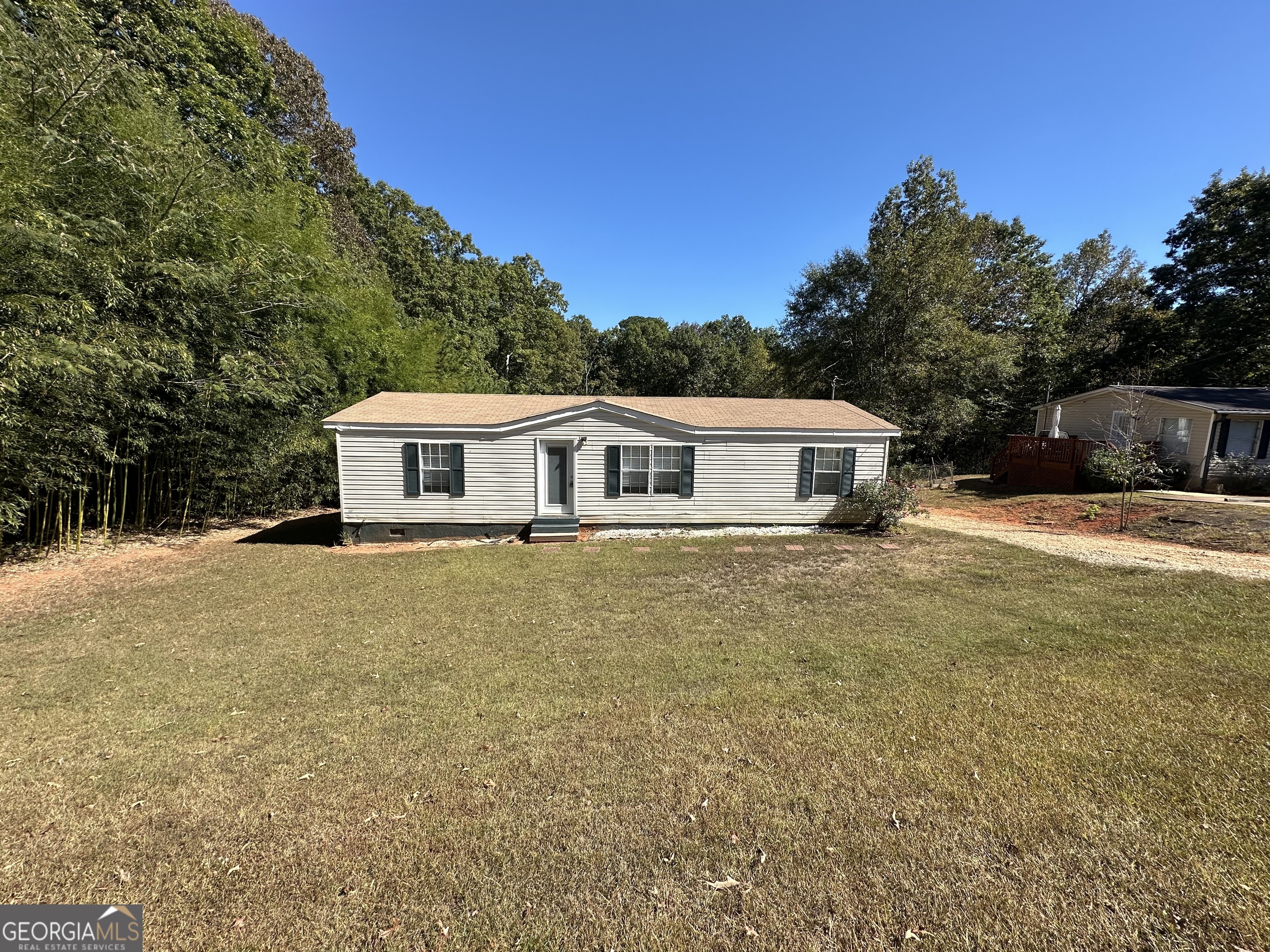 Great starter home or investment property. 3 bedrooms, 2 baths on almost 1 acre (.88). This home features an updated kitchen with granite countertops & tile floor, owner's suite bath has an updated double vanity with granite countertop, tile floor, separate shower & soaking tub, spacious owner's bedroom with large walk-in closet, kitchen is open to the family room and features a vaulted ceiling, split bedroom plan for privacy, (fridge, washer & dryer included), roof is approx. 5 years old and private back yard with storage building. Centrally located to Covington, Conyers & McDonough. Contact your Realtor to schedule your private showing.