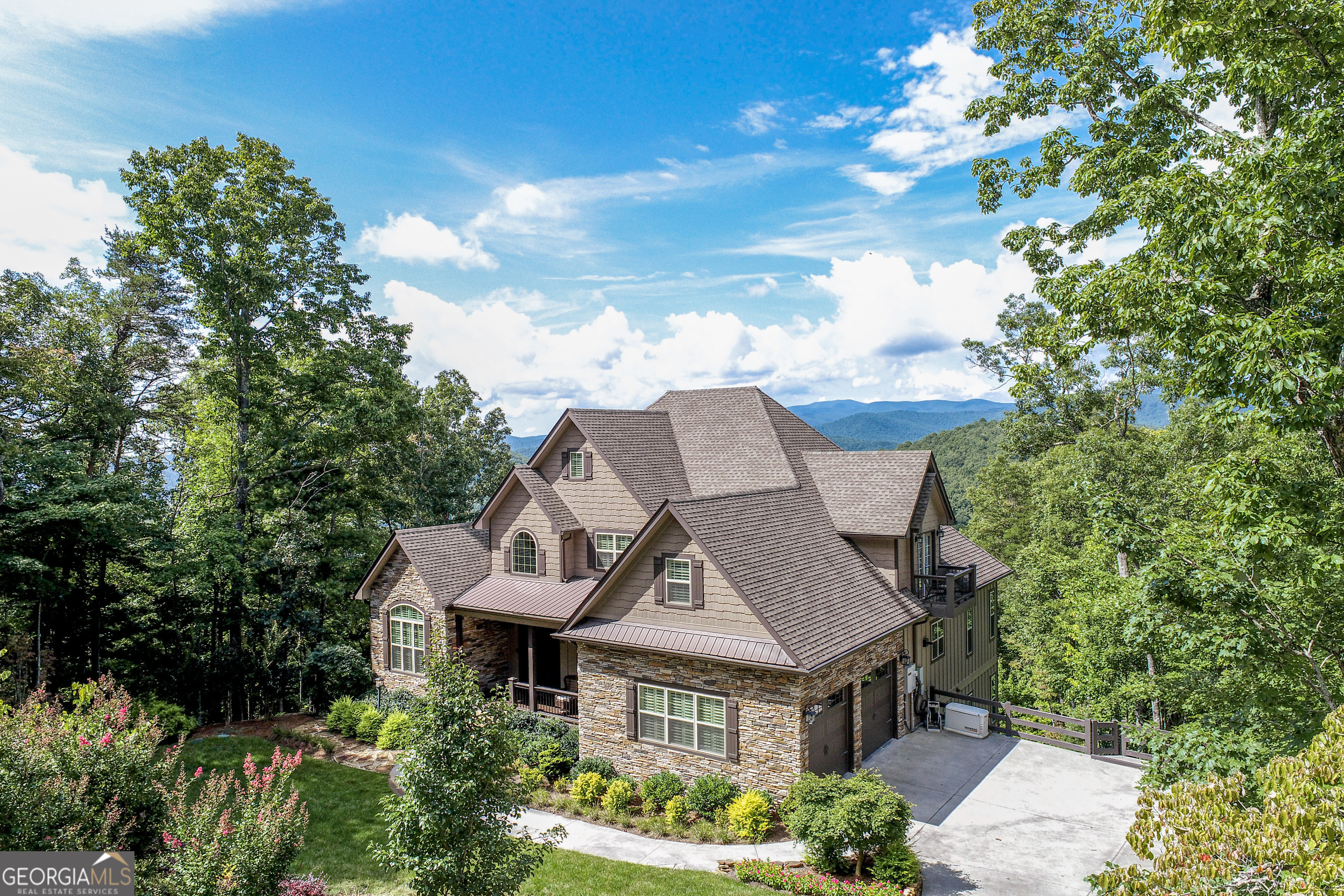 Exceptional Mountain Retreat with Panoramic Lake and Mountain Views Located in Waterfall at Lake Burton | Elevation 2,380 ft Perched atop one of the most breathtaking ridgelines in all of Northeast Georgia, this exceptional home offers unrivaled views in every direction. Set on an estate-sized lot within the prestigious gated community of Waterfall at Lake Burton, the property boasts sweeping vistas of Lake Burton, layered Blue Ridge Mountains to the west and south, and the peaceful valley and eastern ridgelines-all visible from the comfort of your home. Enjoy the tranquil sounds of a custom water feature as you relax on the front porch, or take in both sunrise and sunset from multiple vantage points throughout the residence. This 2018 custom-built home was thoughtfully designed and meticulously overseen by the owner, whose extensive building expertise is reflected in every detail. Constructed as a personal dream home, only top-tier materials and low-maintenance finishes were selected to ensure lasting quality and ease of ownership. For added functionality and peace of mind, the home features a second full kitchen-ideal for entertaining, guest accommodations, or flexible living-and is equipped with a partial-home generator to provide essential power during outages. Additional highlights include: Sturdy, quality construction built to exacting standards Oversized two-car garage with generous storage and workspace Unobstructed views from three sides of the home Covered front porch with relaxing water feature Flexible layout with indoor/outdoor living spaces Second kitchen enhances convenience and preparedness Be sure to view the virtual walkthrough to experience the full beauty and craftsmanship of this exceptional mountain estate. A rare offering in one of Lake Burton's most scenic settings.