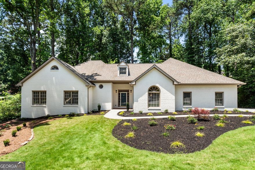 Tucked at the end of a quiet cul-de-sac in the highly sought-after Harrison High School district, this beautifully renovated home blends luxury, comfort, and convenience-just a stone's throw from The Avenue West Cobb and premier shopping and dining. Inside, you'll find three spacious bedrooms and 2.5 baths on the main level, all enhanced by brand-new LVP flooring that flows seamlessly throughout. The bright, designer kitchen features crisp white 42" cabinets, new stainless steel appliances, a stunning sage tile backsplash, and sleek quartz countertops for a polished, modern finish. Start your mornings in the serene screened-in sunroom just off the kitchen-perfect for enjoying coffee and tending to your plants in peace. The oversized primary suite offers French doors that open onto a private back deck surrounded by nature. Unwind in the spa-like ensuite bath with a freestanding soaking tub and custom-tiled luxury shower. All full bathrooms throughout the home are thoughtfully upgraded with a combination of quartz and granite countertops and stylish tile finishes. Upstairs, two oversized bedrooms share a beautifully updated full bath and are connected by a versatile loft-ideal for a second living area, office, or playroom. A separate formal dining room is ready for entertaining, while the laundry room includes a utility sink for added function. The finished basement expands your living space with a large open area perfect for recreation or a home theater, already stubbed for a full bath. A separate basement-level garage provides an ideal space for a workshop, gym, or extra storage-preserving the main-level garage for daily use. With tons of storage throughout and thoughtful upgrades at every turn, this home offers a flexible layout that fits every lifestyle. Homes of this quality in this school district rarely last-schedule your private tour today.