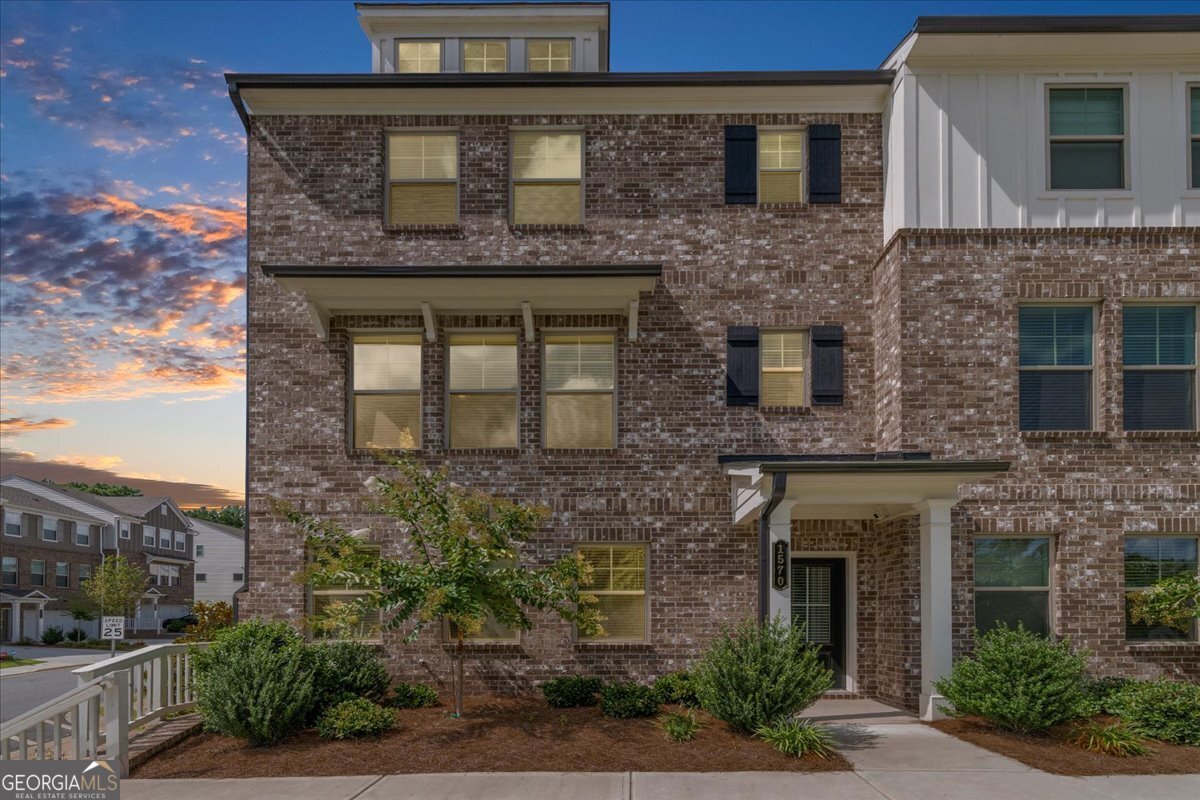 Welcome to 1570 Halbrook Pl. SW located in beautiful South Cobb! This end unit townhome is move in ready! Only 1 year with plenty of upgrades! As you enter the home, you have a welcoming entry foyer. There is a full guest suite with full bath on the main level of the home, as well and the 2-car rear entry oversized garage. The second level of the home features an open concept family room with fireplace, eating area, and beautiful kitchen with plenty of cabinet space, granite countertops, and a large walk-in pantry. There is also access to the oversized rear deck. There are tons of windows on for lots of natural light. Upstairs feature an additional guest bedroom with private bath and walk in closet, full laundry room, and the primary suite with private bath, and walk in closet. The primary bath has double sinks, a private toilet room, and walk in shower. This unit has beautiful floors, great accent walls, and beautiful lights and fans throughout. Faux wood blinds throughout. Level private driveway. Easy walk to the community mailboxes, and firepit area. You are close to HWY 285, Truist park, Cobb Galleria, Cumberland Mall, and so much more! Call today to learn more about this great home!