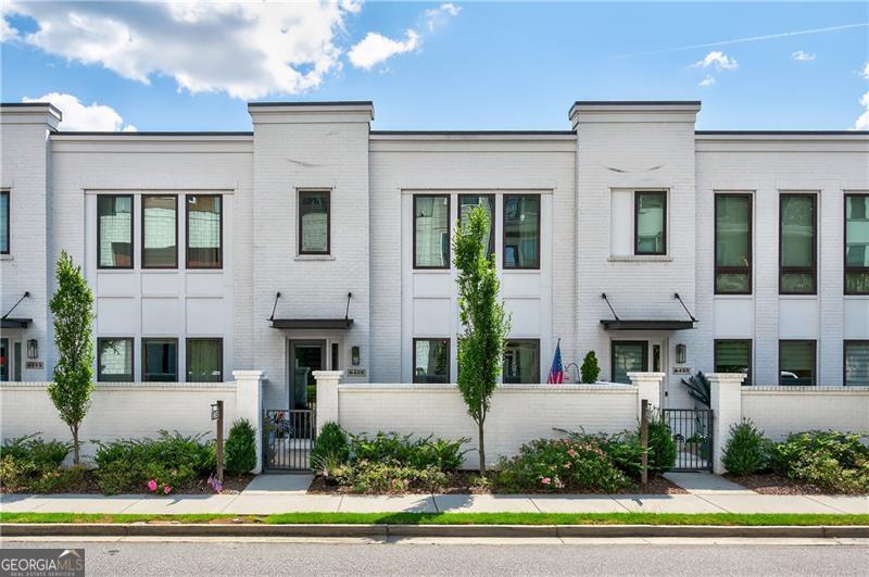 Welcome to your better-than-new dream townhome in the heart of Halcyon-one of Atlanta's most vibrant and walkable communities. Perfectly positioned with direct access to everything Halcyon has to offer, you're just steps away from Trader Joe's, top-rated restaurants, breweries, boutique shopping, a luxury movie theatre, state-of-theart gym, golf simulator, outdoor games, walking trails, dog park, and year-round events that bring neighbors together. This home blends modern luxury with community living in a way that few properties can - offering not just a home, but a lifestyle. Inside, you'll find a thoughtfully designed layout filled with natural light, hardwood flooring throughout, custom lighting, and upscale finishes. The main level features decorative ceiling beams across the living room, a separate dining area, and a stunning chef's kitchen with quartz countertops, stainless steel appliances, soft-close cabinets, and exceptional storage space. Upstairs, all three spacious bedrooms feature their own en-suite baths and large closets making this unlike any other townhome in the Halcyon community! The luxurious primary suite has an oversized walk-in closet, double vanity, soaking tub, and a large walk-in shower with built-in seating. The 2-car garage is a true standout, with soaring ceilings, a private storage room, and reinforced overhead storage that holds up to 1,500 pounds. Enjoy your morning coffee on the charming front porch or end the evening with wine by the firepit before walking to dinner. All of this comes with Forsyth County taxes and an Alpharetta address! You don't want to miss out on this opportunity!