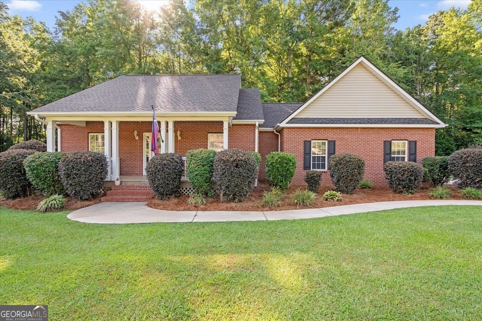 OPEN HOUSE: Tuesday, July 29th 11 am - 1:30 pm. She's a brick... HOUSE!! And she's got all the right features in all the right places. This classic brick ranch beauty brings all the charm with 3 bedrooms *plus* a bonus room that can flex to fit your lifestyle- use it as a 4th bedroom, home office, designated dining space, playroom, or whatever your heart desires! Inside, you'll find freshly refinished hardwood floors, new carpet, and fresh paint in the bedrooms, and an open floor plan that just flows perfectly. The kitchen is a total vibe, featuring a breakfast bar, walk-in pantry, and all appliances included. The spacious living room centers around a cozy wood-burning fireplace, while French doors open to a dreamy screened-in back deck overlooking a spacious, peaceful backyard. The primary suite is a true retreat, featuring elegant tray ceilings, tons of natural light, a generous walk-in closet, and a spacious en suite bathroom complete with double vanities, a relaxing soaking tub, and a separate walk-in shower. Enjoy peace of mind for years to come with a 3-year-old roof and water heater. With a spacious 2-car garage, creek on the property, and beautiful, mature landscaping, this home is nestled in a quiet, established neighborhood within the highly sought-after Central school district- just minutes from downtown Carrollton and a quick drive to I-20. She's mighty mighty, full of fresh updates, and completely move-in ready. Come see this *BRICK HOUSE* before someone else dances away with it.