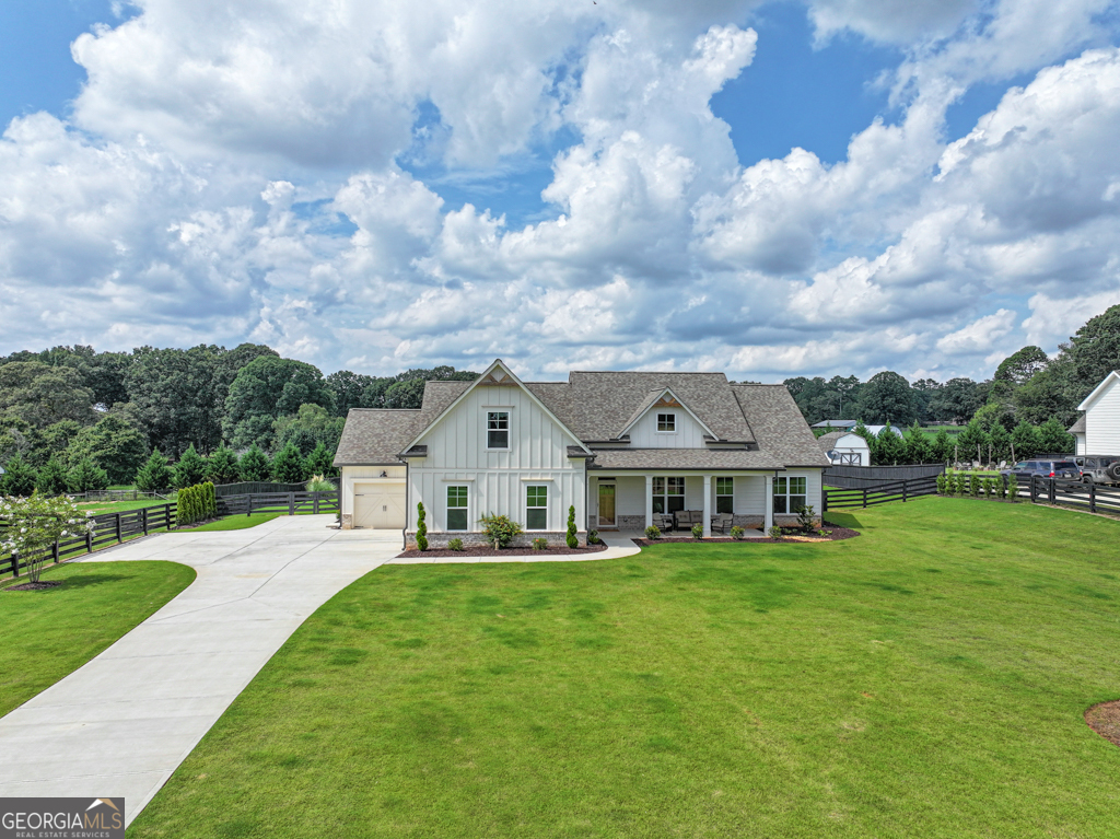 This nearly new, beautifully maintained farmhouse-style home offers the perfect blend of charm, space, and modern convenience. Featuring 4 bedrooms, 3.5 baths, and a three-car garage, this home sits on over 1 acre in a desirable location close to Hwy 316, schools, and shopping. Designed with upgraded flooring and finishes throughout, the open-concept layout includes a vaulted ceiling in the family room and laminate hardwood flooring in the main living areas. The kitchen boasts granite countertops, custom cabinetry, designer lighting, and a large island with views into the family room making it ideal for everyday living and entertaining. The spacious primary suite includes a luxurious bath with a custom tile shower. Outside, enjoy a gated front entrance and fenced backyard-perfect for privacy, pets, and outdoor gatherings. Hardiplank siding with brick accents completes the clean, classic farmhouse look. A rare find that combines comfort, style, and location-this home is move-in ready and a must-see! ** PROFESSIONAL PICTURES COMING SOON** ***OPEN HOUSE SUNDAY 8/24/25 2PM-4PM ***