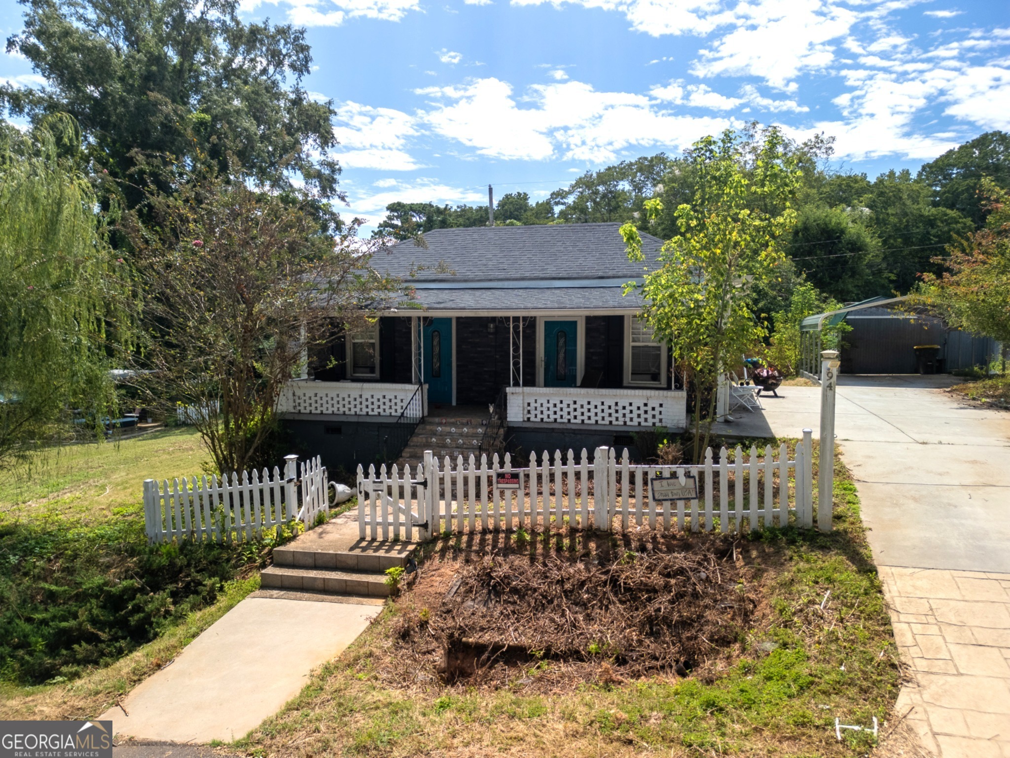 Hidden Gem - Great Investment Opportunity! fully renovated bungalow cottage combines timeless charm with a modern farmhouse design. Situated on two spacious parcels of land, this property offers a rare opportunity to own a cottage with acreage that can be transformed into your own private oasis.A Classic white picket fence frames the front, while a privacy fence encloses the backyard for seclusion and enjoyment.Inside, you'll find engineered hardwood floors, exposed beams, and an open layout leading to a chef's kitchen featuring stainless-steel appliances, white glass cabinetry, and granite countertops. A solar-powered gate provides added convenience and security.Conveniently located near Historic Downtown Newnan, Ashley Park shopping, and Interstate 85, this hidden gem is perfectly positioned for both comfort and accessibility.Whether you're seeking a personal residence or an income-producing property, this home is ideal for long-term or short-term rental opportunities. Don't miss out-come place your bid before it's gone!