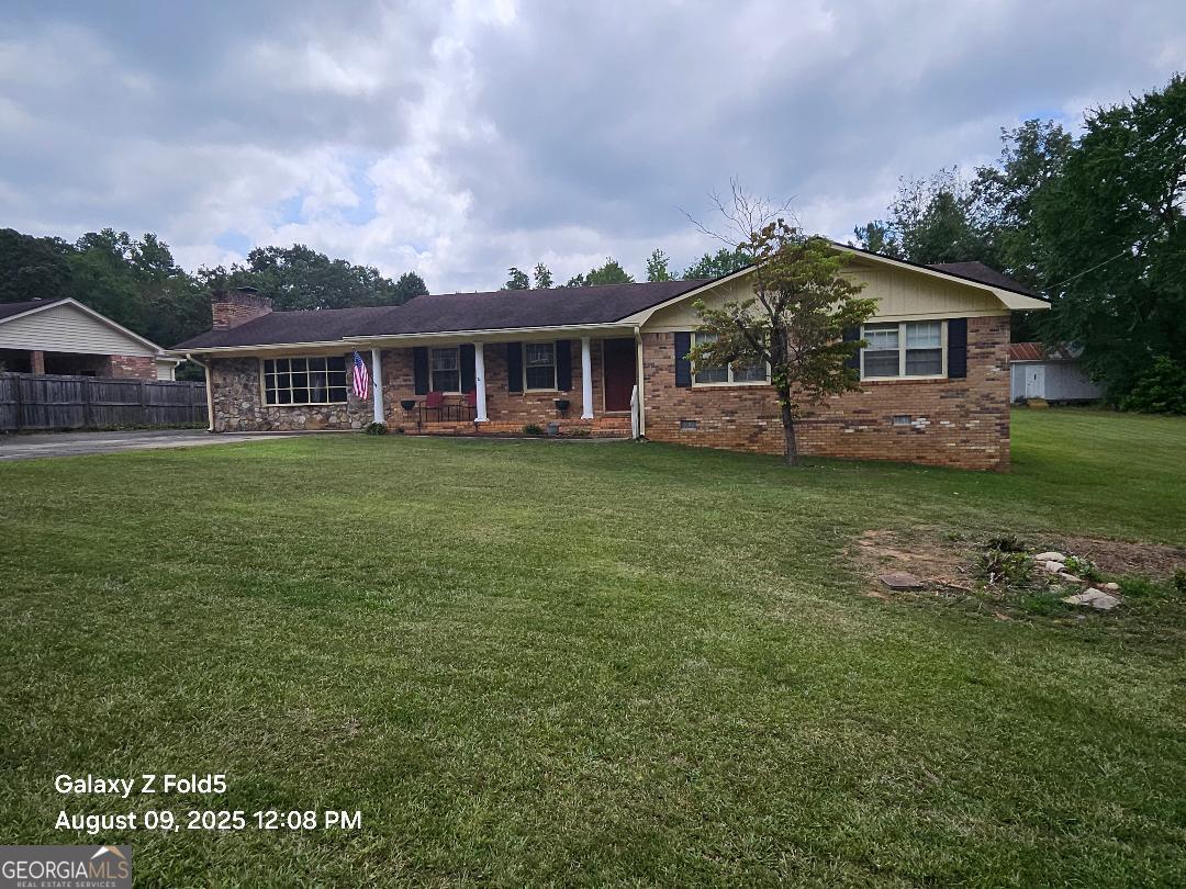 You won't be disappointed with this one. Beautifully updated family room with huge fireplace and room for everyone. Updated kitchen/den area with another fireplace for cozy evenings. Formal living room/dining room combination. 3 bedrooms and 2 full baths. Enjoy the covered back porch area/sunroom (no heat and air) and screened porch. PLUS a covered patio and cookout area, 3 storage buildings and sitting on .76 acre level lot. Qualifies for 100% financing USDA. Updating 2nd bath. Should be ready to show by Sat. 8/23