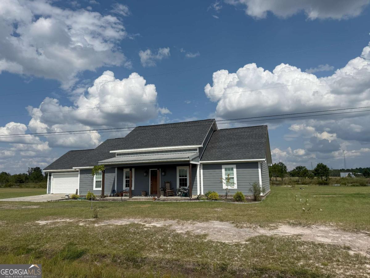 2022 3bdrm/2bth home with 20' lofty ceiling with OPEN lvrm/dining/kit floorplan. TANKLESS water heater! Masonry gas fireplace is a gorgeous feature in the lvrm with built-in bookcases alongside. Kitchen has a large island, stainless steel appliances, tons of cabinets, and a pantry. Bedrooms have a split floorplan. Main bdrm has a specialty, tray ceiling. Attached bathroom is adequate for handicap needs, featuring a walk-in shower. Very large closet. Rear of home offers a covered patio so you can enjoy the lake view and fish. Attached double garage with door for your privacy & storage needs. Call Jessica Dubberly Carver today at James M. Swain & Assoc., Inc. 229-375-4258 cell or 912-367-3601 office. More photos coming soon!