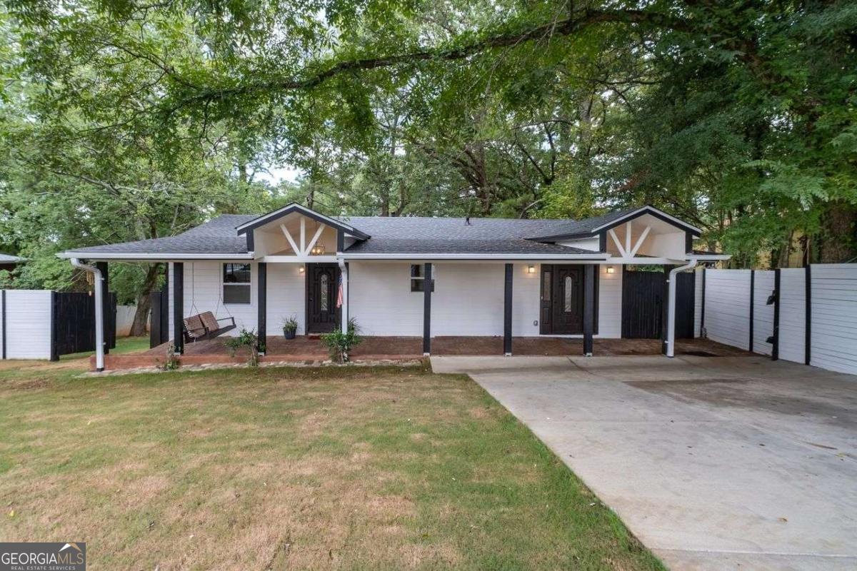 Fully renovated 3BR/2BA home in a community experiencing exciting growth, development, and investment. Sitting on a super large lot of about half an acre, the backyard features fresh Bermuda grass and offers the perfect setting for entertaining, gardening, play, or pets. A gorgeous oversized 400 sq ft front porch with concrete flooring and hanging lights adds charm and creates a welcoming outdoor living space. Inside, an extra versatile room provides additional space that can be used as a mudroom, waiting area, or cozy sitting nook. This beautifully updated property combines modern upgrades with charming curb appeal, featuring a new roof, new HVAC, an expanded driveway with ample parking, and security cameras for added peace of mind. The interior has been thoughtfully renovated with a brand-new kitchen, updated bathrooms, and stylish finishes throughout, offering a truly move-in ready experience. The home sits on a super large lot with double fencing, including a chain link fence and a privacy fence, maximizing both security and usability of the yard. Families will appreciate the convenience of being within walking distance to William J. Scott Elementary. Ideally located close to West Highlands and Perry Blvd, and just minutes from the Atlanta Belt Line, Westside Reservoir Park, Midtown, Buckhead, and a variety of shopping, dining, and entertainment options, this home offers comfort, privacy, and easy access to some of the city's best amenities.
