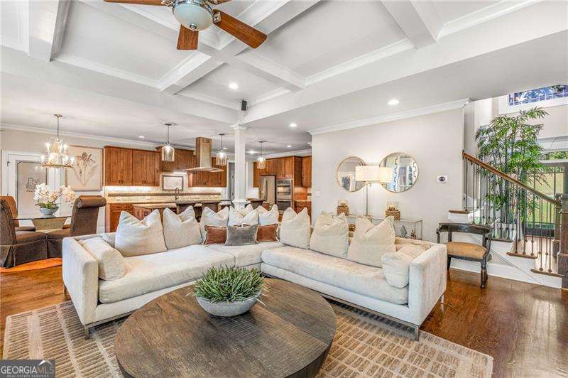 JUST LISTED this gorgeous home with a 4 CAR GARAGE ! Edinburgh's custom home in Bear's Best award-winning golf course community designed by Jack Nicklaus and offers three levels of extraordinary living and elegance. This exquisite home offers 6 spacious bedrooms with a flat backyard overlooking the golf course . There's a spacious covered deck upstairs perfect for outdoor dining and relaxation. Upon entering a foyer with high ceilings this home offers abundant natural light . The open-concept living area is perfect for both entertaining and everyday living, featuring a chef's gourmet kitchen with high-end appliances , mudroom, walk-in pantry and a stylish breakfast nook leading to the covered deck. The family room boasts a cozy stacked stone fireplace .The dining room is perfect for entertaining. The study is located on the main floor along with a guest bedroom on the main level with a private bathroom. Upstairs , the primary suite is a true retreat with a fireplace, a lavish en-suite bathroom with double vanities. The loft / media room upstairs is a perfect game room.The finished basement with very high ceilings with family room space with a fireplace and a wet bar, a large bedroom, walk-in closet and full bathroom. Also, additional unfinished storage space. Edinburgh is a golf cart friendly neighborhood and offers fantastic amenities, including an Olympic-size pool, a waterslide, tennis courts, a fitness center, a playground and a basketball court. The very active homeowners' association plans multiple social events throughout the year. The neighborhood is moments from the Chattahoochee River, a short ride to Suwanee Town Center, Lake Lanier, destination shopping, dining and entertainment. All this in North Gwinnett's award winning schools. Riverside Elementary, North Gwinnett Middle School and North Gwinnett High School. There's an assumable VA loan with low rate if needed.HURRY THIS HOME WON'T LAST LONG!