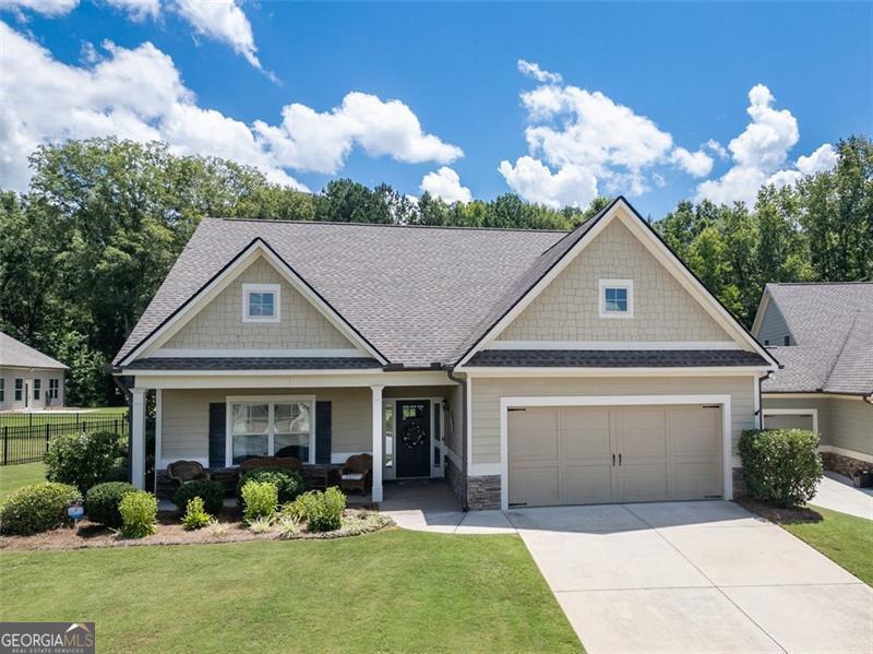 WELCOME TO THIS BEAUTIFUL 3BR/3BA RANCH IN SOUGHT AFTER GRAND HAVEN AT ALCOVY MOUNTAIN, A 55+ ACTIVE ADULT & GATED COMMUNITY! It's One of the Rare Homes that Backs Directly to the Mountain and Private Green Space! It boasts a Professionally Designed and Beautifully Landscaped Rear Yard that's Fully Enclosed with Wrought Iron Fencing-Perfect for furbabies! Enjoy Private Views of the Mountain as you Relax in your Sunroom or Under the Shaded Pergola and Covered Patio! Experience all the Amenities of Grand Haven including the Large Upscale Clubhouse, Jr. Olympic-size Pool, Tennis, Pickle Ball, Bocce Ball, Playground, Dog Park, Daily Activities(bingo, fitness, art, social mixers) and Complete Lawn Care! This Open-Concept home was Custom Designed to be Larger with an Oversized Primary and Secondary Suite on the Main level as well as an Expanded Island Kitchen that flows seamlessly with the Oversized GR & Dining Spaces that are Ideal for Family Gatherings or Entertaining! Upstairs features a Loft & 3rd BR with an En suite Bath-a Great Retreat for Guests or Home Office! Freshly Painted Interior, Upgraded Engineered Hardwood Floors throughout Main level (except 2nd BR), Granite Countertops, Walk-in Pantry, Tiled Baths! Located MInutes to Vibrant Downtown Monroe, Shopping, and Medical Facilities! Don't miss out on this Awesome Opportunity that is Ready for Move-in!