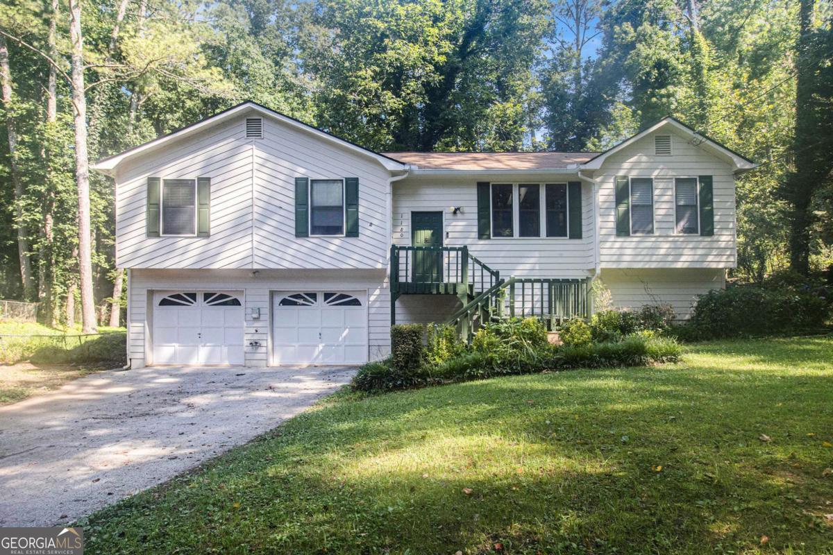 Located near Toonigh Rd and Hickory Rd in Canton, GA, this multi-split home offers 3 bedrooms and 2 full bathrooms on a spacious, tree-lined lot. The living room features a stone fireplace as its centerpiece and flows openly into the dining area, with large sliding glass doors leading to a covered patio-perfect for indoor-outdoor living. The primary ensuite includes a tub/shower combo, and the unfinished basement provides ample storage space. Surrounded by mature trees and offering a large backyard, this home combines comfort, space, and natural beauty. Discounted rate options and no lender fee future refinancing may be available for qualified buyers of this home.