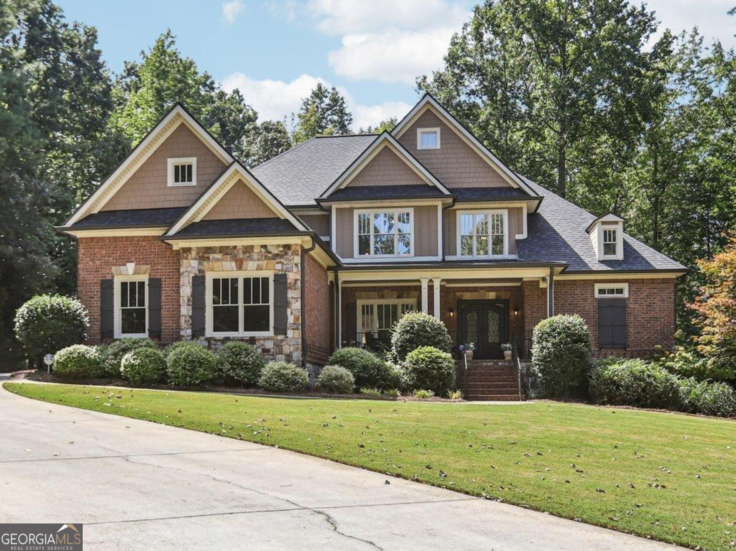 Located in the sought-after Arbor Springs community, this updated 5-bedroom, 3.5-bath residence offers modern luxury and refined living on over an acre of private land. Designed with both style and functionality in mind, the home showcases fresh interior paint, rich hardwood floors, new recessed lighting, and a dramatic two-story coffered ceiling in the family room, accented by a grand chandelier. The fully remodeled kitchen is a true centerpiece, featuring granite countertops, resurfaced cabinetry, a KitchenAid double oven, Bosch five-burner cooktop, and built-in Frigidaire Gallery microwave-all set within an open layout ideal for everyday living and entertaining. An elegant formal dining room provides the perfect backdrop for gatherings, while multiple gas fireplaces throughout the home create a warm, inviting atmosphere. The main-level primary suite is a private retreat with vaulted ceilings, an oversized walk-in closet, and a spa-inspired bath complete with a soaking tub, oversized glass shower, granite counters, and new flooring. Upstairs, spacious secondary bedrooms and updated guest baths ensure comfort for family and guests alike. Additional highlights include new carpet throughout, a custom iron front door, and a brand-new roof. The basement offers a completed HVAC system, a dedicated wood workshop, and ample unfinished space ready for a media room, gym, or in-law suite. Outdoor living is equally impressive, with a Trex deck system, built-in stone firepit with seating, and a wooded backyard designed for relaxation and entertaining. Ideally located just minutes from Publix and Highway 29, this property blends timeless design, modern updates, and a prime location in one exceptional package.