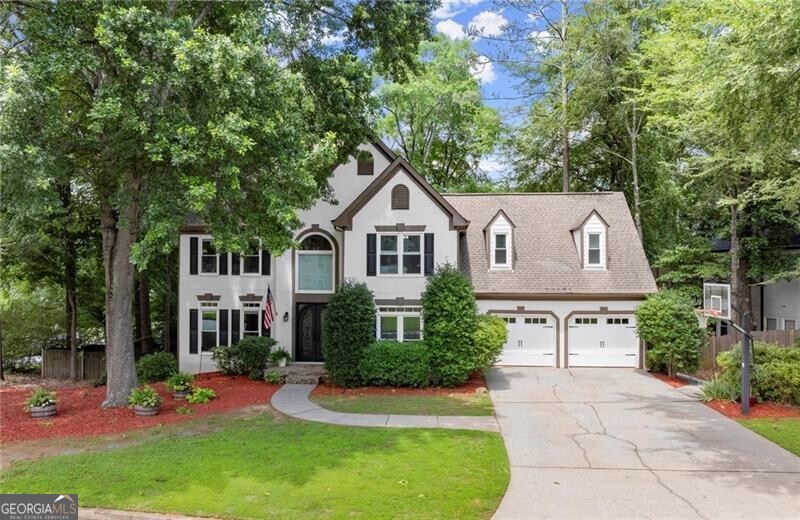 This beautiful home with a finished basement in the highly sought-after Park Forest subdivision sits on a desirable corner lot with loads of curb appeal, mere steps from the community swimming pool, clubhouse, and tennis courts. Perfectly located within walking distance of top-rated schools, including Alpharetta High, Webb Bridge Middle and Creekview Elementary, you'll also enjoy the convenience of being less than a 10-minute drive from Avalon and Downtown Alpharetta, where shopping, dining, and entertainment await. The home welcomes you with a grand first impression with stunning wrought iron double doors, featuring intricate scrollwork and arched glass panels that exude elegance and timeless craftsmanship. Set against a stacked stone entry and framed by lush greenery, this impressive entrance welcomes guests with charm and sophistication. As you enter, you're greeted by a dramatic two-story foyer leading to a private office on the right, featuring french doors for added privacy and a custom bookshelf that doubles as a secret hidden door that opens to the kitchen. The versatile main floor also includes a formal living room to the left offering ample space for gatherings. Either the office or formal living room could easily be used as a formal dining space to fit your needs as well. The heart of the home boasts an open-concept floor plan, with a spacious kitchen seamlessly connecting to the family room. The inviting family room is filled with natural light, thanks to a wall of windows overlooking the wooded backyard. You'll love the cozy fireplace and custom built-in bookcases. The spacious chef's kitchen with an abundance of cabinets and storage features a sunroom breakfast nook with soaring ceilings and a beautiful arched window, plus a bar for a casual dining option. The main floor is complete with a charming laundry room, making day-to-day living a breeze and a powder bathroom - perfect for guests. Upstairs, the oversized primary suite welcomes you with tray ceilings and a luxurious renovated bathroom featuring dual vanities, a separate soaking tub, and a beautifully designed walk-in tile shower with river rock flooring. The primary suite also features a spacious walk in closet with his and hers sides. Three additional spacious secondary bedrooms are found on the upper level, with one boasting a private en suite bathroom while the other two share a well-appointed bathroom. But that's not all! The finished basement is thoughtfully utilized by the current owners with a game room, home gym, stylish bar lounge, cozy bunk room, an additional bedroom, and a full bathroom-offering space for relaxation, recreation, and hosting guests. With its flexible layout, the new owners can easily customize these rooms to fit their own unique lifestyle, whether that means a media room, home office, playroom, or anything in between. Step out from the basement onto the walkout patio, a peaceful spot to relax and enjoy the outdoors. Above, the expansive back deck is perfect for entertaining, overlooking the large, flat backyard with multiple levels, fire pits, and ample space for a playground, trampoline, or whatever suits your lifestyle. The beautifully landscaped front yard adds curb appeal to this prime corner lot, making a lasting impression from every angle. Don't miss this incredible opportunity to own a stunning home in an unbeatable location.