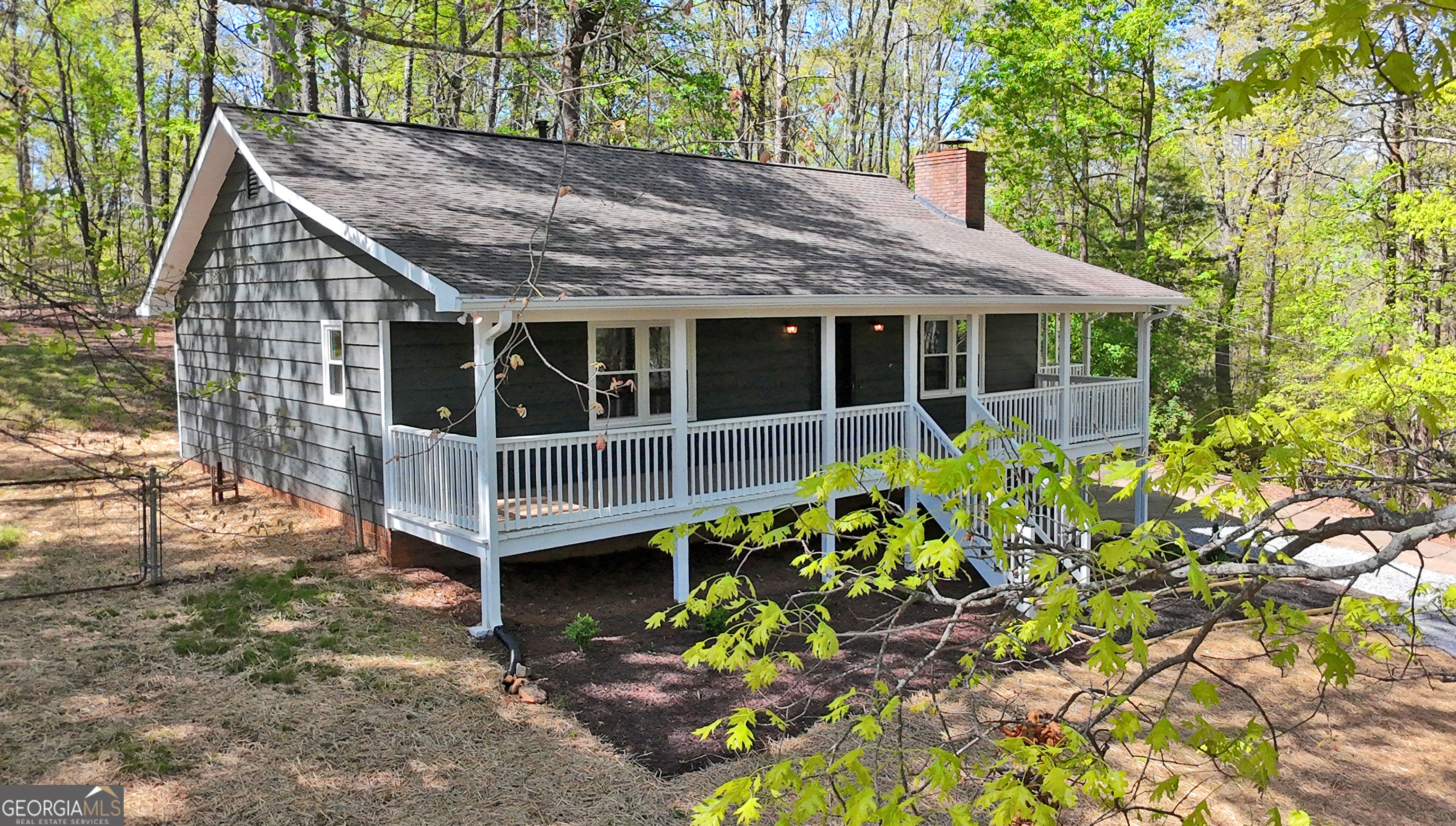 This ranch style cottage is situated on a quiet wooded hilltop and has just been completely renovated and updated. Everything is new including HVAC, plumbing fixtures, lighting, flooring, interior and exterior painting, doors and door hardware, new high-efficiency tilt-in glass windows, flooring, kitchen cabinets and appliances, plumbing fixtures, sheetrock and trim, closet shelving, whole house fan, gutters and downspouts, landscaping, parking pads. No HOA so park your RV or boat on one of the new parking pads. The roof is five years old. The home also features large covered front and side porches and a fenced backyard is perfect for dogs. Inside features a wood burning, rock-faced masonry fireplace, perfect for those chilly winter nights. Located less than a mile from Rhinehardt University, this property is across the street from the college's 7 mile system of mountain biking and hiking trails. The square footage from the public records does not include the full daylight basement which is heated and cooled and ready for an additonal bedroom, office, bath or rec room. The owner is a builder and will work with the new owner to build their dream at a minimal finishing cost providing endless possibilities for customization. This home is move-in ready and is perfect for any family, investors looking for a rental property or retirees as a second home. And Canton, booming with new retail, restaurants and entertainment is five miles away. The Callahan public golf course is one mile away and the new Publix grocery store at Laurel Canyon Village is three miles away. The property is like living in the quiet peaceful mountains but close to all the city amenities.