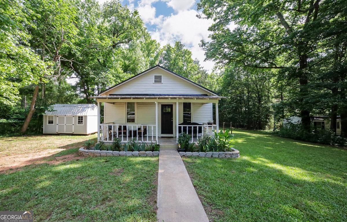 Investment Opportunity, Starter Home, Ideal for Downsizing This renovated Sherwood Forest cottage offers a stacked deck of options! DETAILS: *2 Bedrooms/1 Full Bath *775+/- SqFt. *Year Built - 1900 *Renovated - 2021 *Expansive .502 Acre Lot. SPECIAL FEATURES: Metal Roof (2021) Updated HVAC & Insulation (2021) Designers-choice Paint Palette 9ft. Ceilings Updated Light Fixtures & Ceiling Fans Luxury Vinyl Plank Floors Cordless Blinds Package Updated Kitchen & Bathroom. FLOOR PLAN: -Open, Living/Dining Plan. -Upon entry youre received by the inviting living room, sun-drenched with multiple windows allowing natural light to highlight the space. -Providing a seamless transition, the living area overflows to the updated eat-in kitchen. -Ample space is available for a bistro table, and additional seating is offered with the breakfast bar. -Perfectly updated with modern touches, the kitchen features wrap-around counters allowing plenty of room for meal prep, upgraded sleek white cabinets accompanied by brushed-nickel hardware, double-basin sink, and stainless steel appliance package. APPLIANCES: ~Smooth top Stove/Oven combination ~Dishwasher ~Vent-hood Microwave ~Side-by-side Refrigerator with ice/water dispenser. -Just off the kitchen is the mudroom-styled Laundry Room complete with storage closet and access to the rear yard. -Spanning the left side of the home are 2 cozy bedrooms flanking the updated full bath. Each bedroom offers ceiling fan light fixtures, LVP floors, multiple windows, and private, ensuite access to the full bath. EXTERIOR: ~Covered Rocking Chair Front Porch lined with Garden Beds. ~Private Rear Deck. ~Fenced Rear Yard. ~Storage Building. ~Manicured Lawns EXTRAS: -Public Water and septic tank, -All Electric Systems, -Ample Parking. LOCATION: Less than .5 mile to the heart of Danielsville. Within minutes to MC High School 20 miles to Athens. 14 miles to Royston. 15 miles to Commerce. Charming, Cute & Cozy This spectacular Cottage not only offers an affordable price, but blends modern updates and desirable details that you do not want to miss!!
