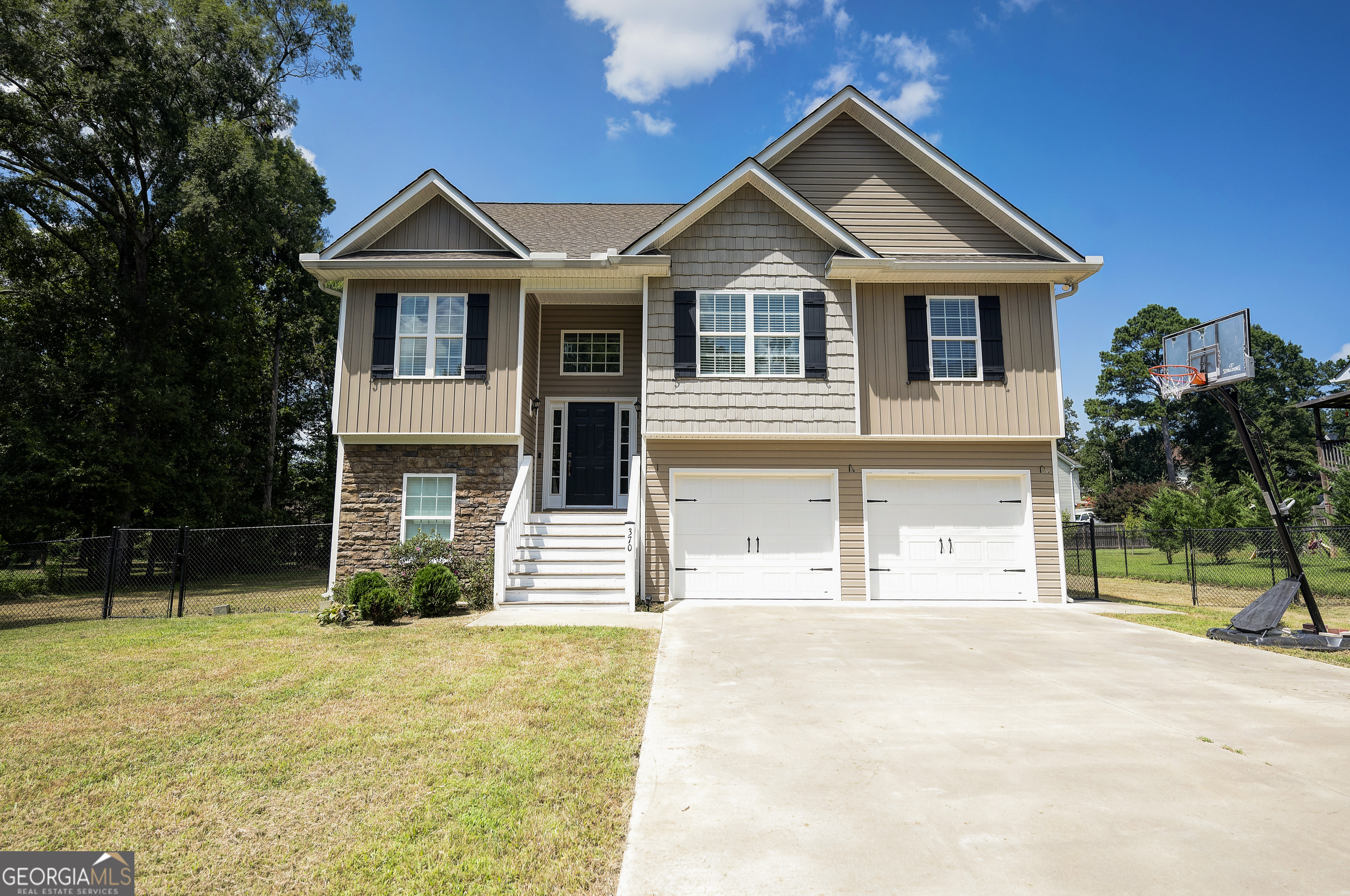 MESMERIZING IN MEADOWBROOK AND MOVE-RIGHT-ON-IN-READY! Stately split-foyer in picture perfect condition located inside CALHOUN CITY LIMITS! The breathtaking facade greets you with timeless CURB APPEAL, featuring faux stone, vinyl- shake and board-and-batten accents, ARCHITECTURAL-STYLE ROOFING, onyx shutters, and charismatic carriage package on the DOUBLE GARAGE DOORS. The front entry accesses the staircase, which travels up to the home's main level. Inviting living room welcomes guests with CATHEDRAL CEILINGS, RECESSED LIGHTING, and SOLID SURFACE FLOORING. The generous galley-style kitchen is equipped with SUBWAY TILE BACKSPLASH and STAINLESS APPLIANCE PACKAGE. The OWNER'S RETREAT includes a sizable bedroom, which is adorned with TRAY CEILINGS, and TWO WALK-IN CLOSETS are in place for many fashions. PRIVATE ENSUITE features a SOAKING TUB and SEPARATE SHOWER. Travel down to the LOWER LEVEL, which is impressive to say the least! Spacious FLEX ROOM/4TH BEDROOM opens to FULL BATH, and also has EXTERIOR ACCESS. Enjoy al fresco dining and outdoor entertaining on the BACK DECK, which overlooks the SPACIOUS, FENCED BACKYARD. This home has gorgeous features, including SOLID SURFACE FLOORING THORUHOUT, and as added perks, the WASHER, DRYER, and REFRIGERATOR can be included with purchase! There is also neighborhood access to Calhoun Primary and Calhoun Elementary Schools. Enjoy all this property has to offer with NO HOA FEES! Welcome Home to 370 Wildwood!