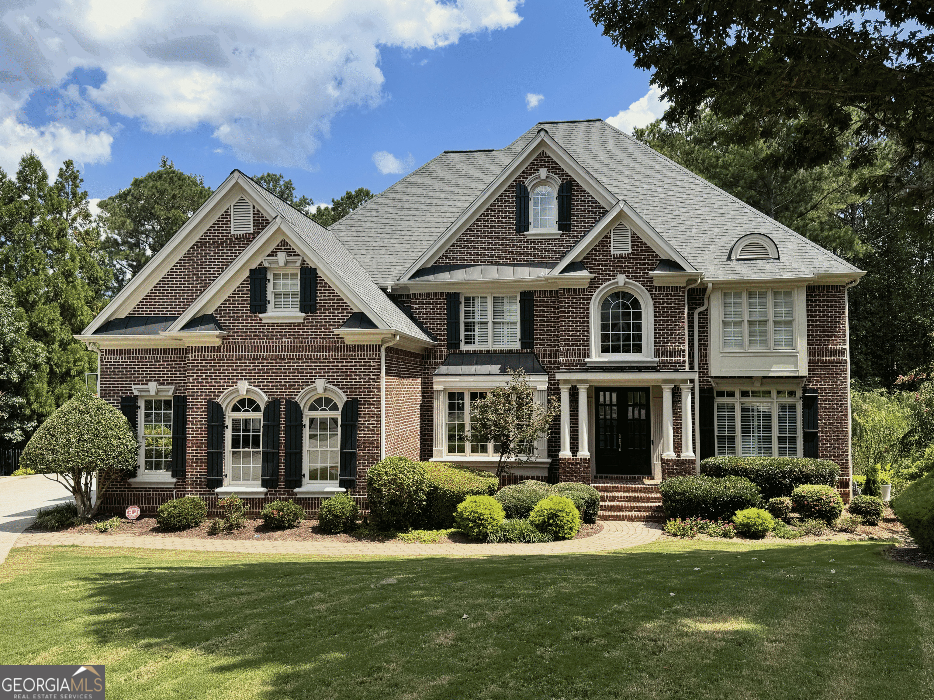 Experience the perfect blend of charm and elegance in this meticulously designed Southern Living home. Nestled in a quiet cul-de-sac on a sprawling 1-acre golf course lot, this residence exudes tranquility and grace, making it a must-see for discerning buyers. Step through the welcoming two-story foyer to a striking executive wood paneled office and a banquet-sized formal dining room. The family room features a cozy fireplace and built-in bookcases, with strategically placed windows that fill the space with natural light, highlighting the rich cabinetry and stunning white quartz countertops. A custom walk-in pantry, breakfast island, and inviting breakfast room complete the heart of the home, while the side entry porch conveniently leads to the three-car garage. The primary suite boasts a gorgeous new spa-inspired bathroom with dual showerheads, a soaking tub, his/hers vanities and his/hers closets. A versatile flex room offers endless possibilities, whether as a gift-wrapping area or an art studio. The multifunctional loft overlooks the expansive backyard, providing a perfect vantage point. All of the bedrooms are oversized, including 3 additional bedrooms upstairs, one guest en suite on main and an in-law suite on the terrace level. The terrace level is an entertainer's dream, featuring a recreation room, custom bar, workout space, bedroom, bath, and additional storage. Outdoor living is taken to the next level with a screened porch, heated saltwater pool and hot tub, outdoor kitchen and bar, a fireplace, and a beautifully crafted patio with stacked stone accents-all within the exclusive Summit at Bridgemill Athletic Club.
