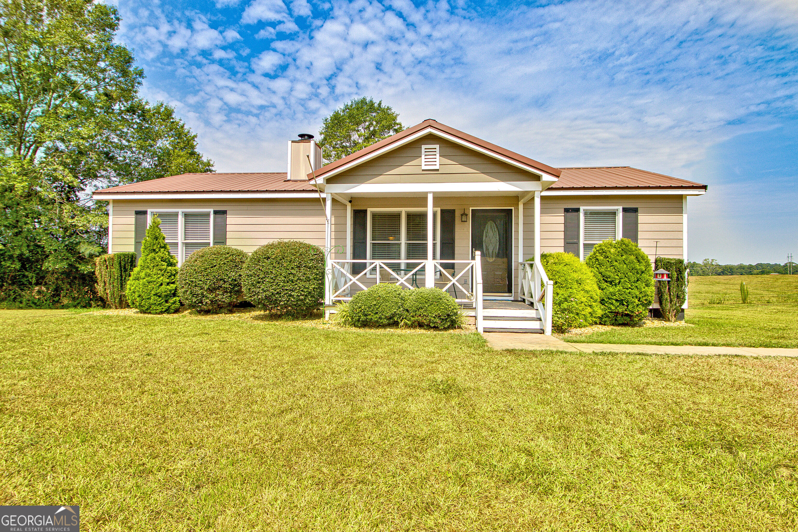 Adorable ranch home on a little over 2 acres! 3 bedrooms, 2 baths that have tub/shower combos and tile floors. Family room with fireplace. Kitchen with eating area and tile floors, laundry room is off the kitchen. 2 parking carports. Front porch and Back deck for grilling and entertaining. Barn with storage and parking. Beautiful land. Property includes two parcels.