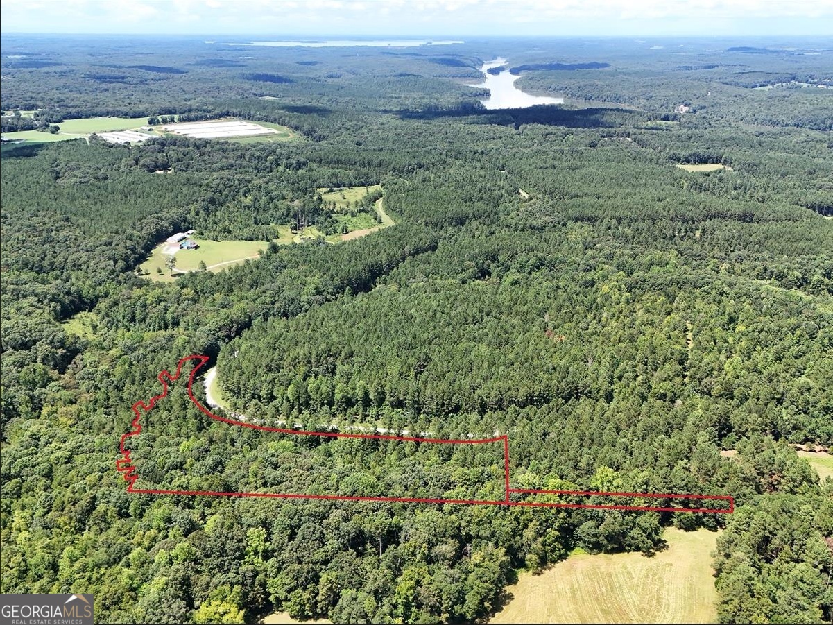 7.4 acres of residential land in the gated Sandy Landing community near Elberton, Elbert County. The lot is wooded with hardwoods and pines and offers potential homesite locations. Access is from Hornets Bridge Road on maintained community roads. Electric service is available at the road. Public water and natural gas are available but not connected. Septic will be required. Recorded covenants and restrictions apply. Lake Russell is located nearby.