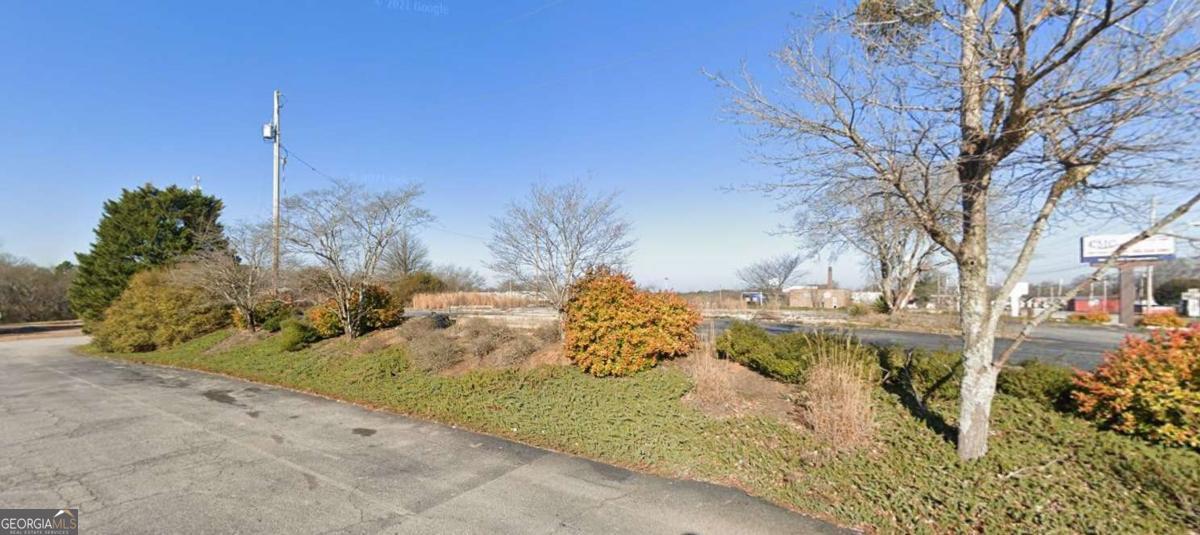 Commercial zoned 0.55 acre vacant Lot in Downtown Commerce. Slab, 16 parking spaces, and 2 drive-through lanes still in place. Public Utilities available. Lot is located next to Advanced Auto Parts. Lanier Technical College, Jackson County Habitat for Humanity & Restore, and Jackson County Health Department are located behind. Across the street is Grits & Grace Coffee House & Cafe and Texaco at Ila Rd.