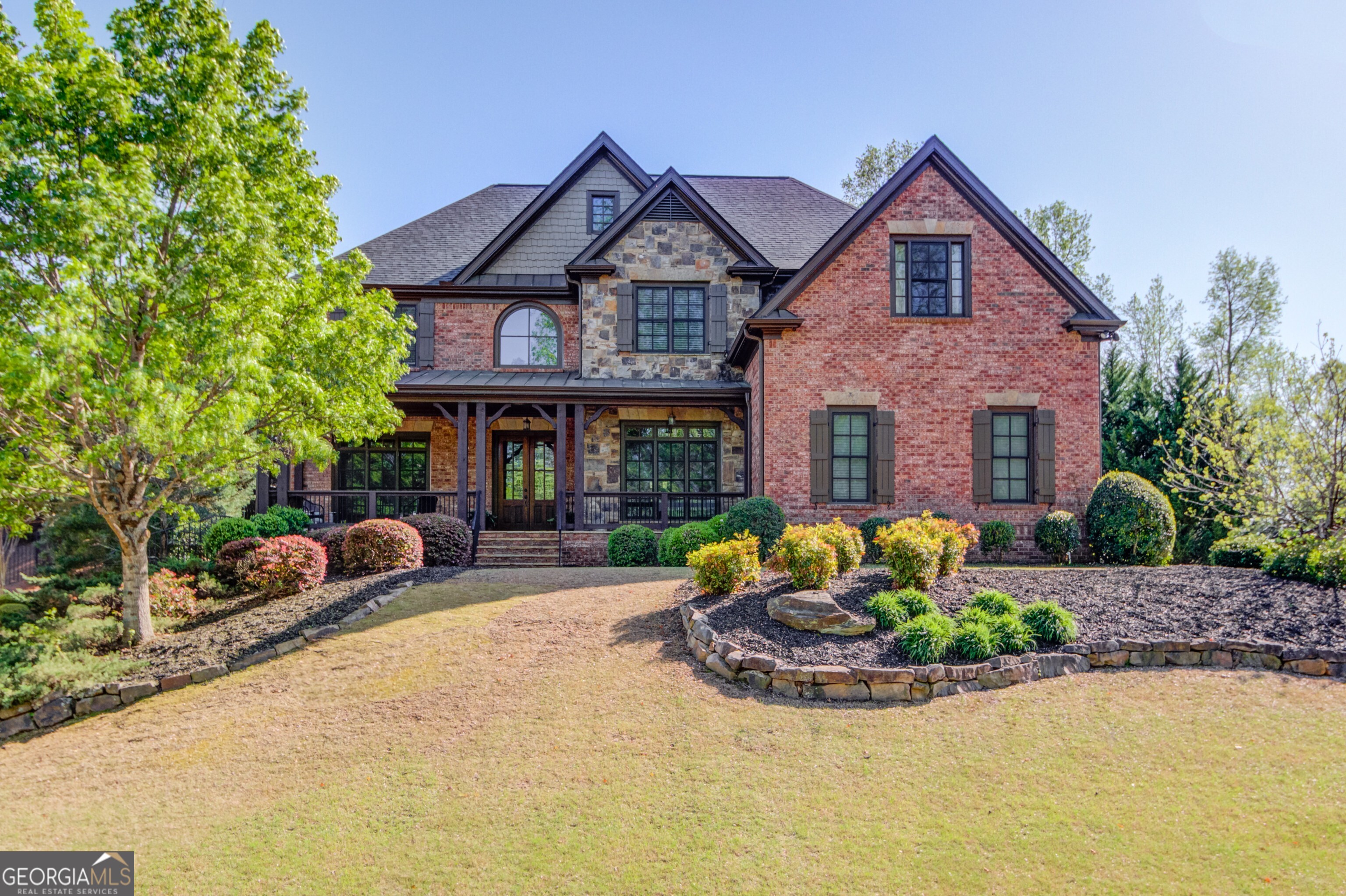 Welcome to your forever home, a stunning blend of timeless elegance and modern functionality, nestled on a private, tree-lined lot in one of Cumming's most family-friendly and sought-after communities. This spacious 6-bedroom, 5 full bath, 2 half bath estate offers the perfect layout for multi-generational living, entertaining, and everyday comfort. Surrounded by mature evergreens, this private lot provides a peaceful retreat with space to create your own outdoor oasis, pool, or custom kitchen area. Step inside to a thoughtfully designed open-concept main level featuring a guest suite on the main, perfect for in-laws or extended stays, and a dedicated home office ideal for remote or hybrid work. The formal dining room sets the stage for memorable gatherings, while the chef-inspired kitchen with breakfast nook opens into a light-filled great room with a stacked-stone fireplace and custom built-ins. Upstairs, you'll find a luxurious primary suite, spacious secondary bedrooms, and two full bathrooms, offering comfort and privacy for the entire household. A versatile loft adds flexibility for a media room, playroom, fitness space, or second living area. The fully finished basement is an entertainer's dream, offering a home theater/media room, wet bar, and a private guest suite with full bath perfect for hosting or long-term guests. This home has Energy-efficient tankless water heater, Three-zoned HVAC system (upstairs unit recently replaced, all systems serviced), Architectural shingle roof installed in 2022, Smart-ready features, and programmable lighting. Outdoor living includes a screened-in porch ideal for shaded relaxation or dining, and an adjacent open-air patio offering additional entertainment space. The Trimlight permanent holiday lighting system adds year-round curb appeal and convenience. Located in a vibrant swim-tennis neighborhood with top-rated Forsyth County schools, enjoy access to parks, lakes, clubhouse, pool, tennis courts, and a lively town square. Friendly neighbors and resort-style amenities make this community ideal for both kids and adults. Elegant, functional, and ready to welcome its next chapter, this home checks every box.