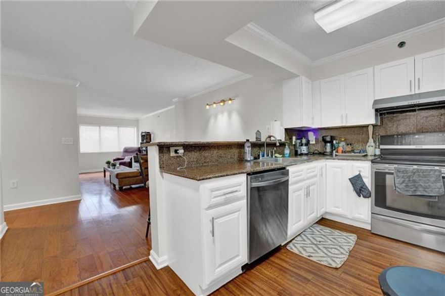 Location! Location! Location! This charming two-bedroom, one-bathroom condo in Sandy Springs offers unparalleled convenience with quick access to I-400 and I-285, plus nearby shopping, dining, parks, MARTA, and more.   Step inside to discover a well-maintained home featuring an open-concept design, a spacious master bedroom with a walk-in closet, and an updated bath. The condo boasts stainless steel appliances, stone countertops, white cabinets, and modern lighting. The kitchen includes a convenient laundry closet and a full pantry for ample storage.  Enjoy peace of mind with 24-hour concierge service, gated parking, and excellent security. Residents have access to a fitness center, swimming pool, dog park, and grilling area. Water and sewer are included in the HOA fees.  This beautiful condo also comes with 2 assigned parking spots, A161 and A310, providing extra security and convience.  Guest parking is available beside the pool.  Please note that parking regulations are strictly enforced  Don't miss this fantastic opportunity to live in one of Sandy Springs' most desirable locations!